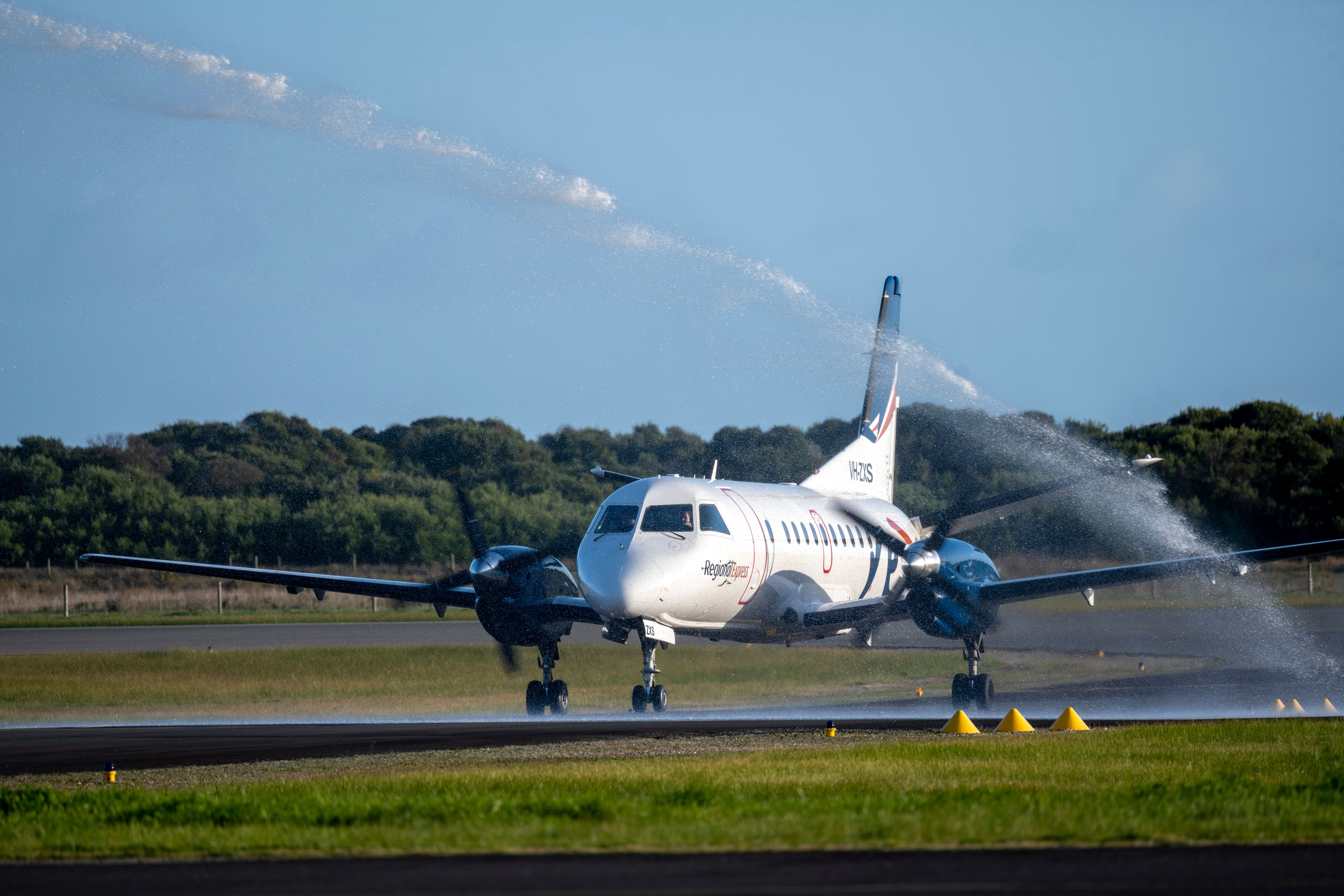 A Saab 340B from Rex landing in Devonport, Tasmania, and receiving a traditional water cannon salute.