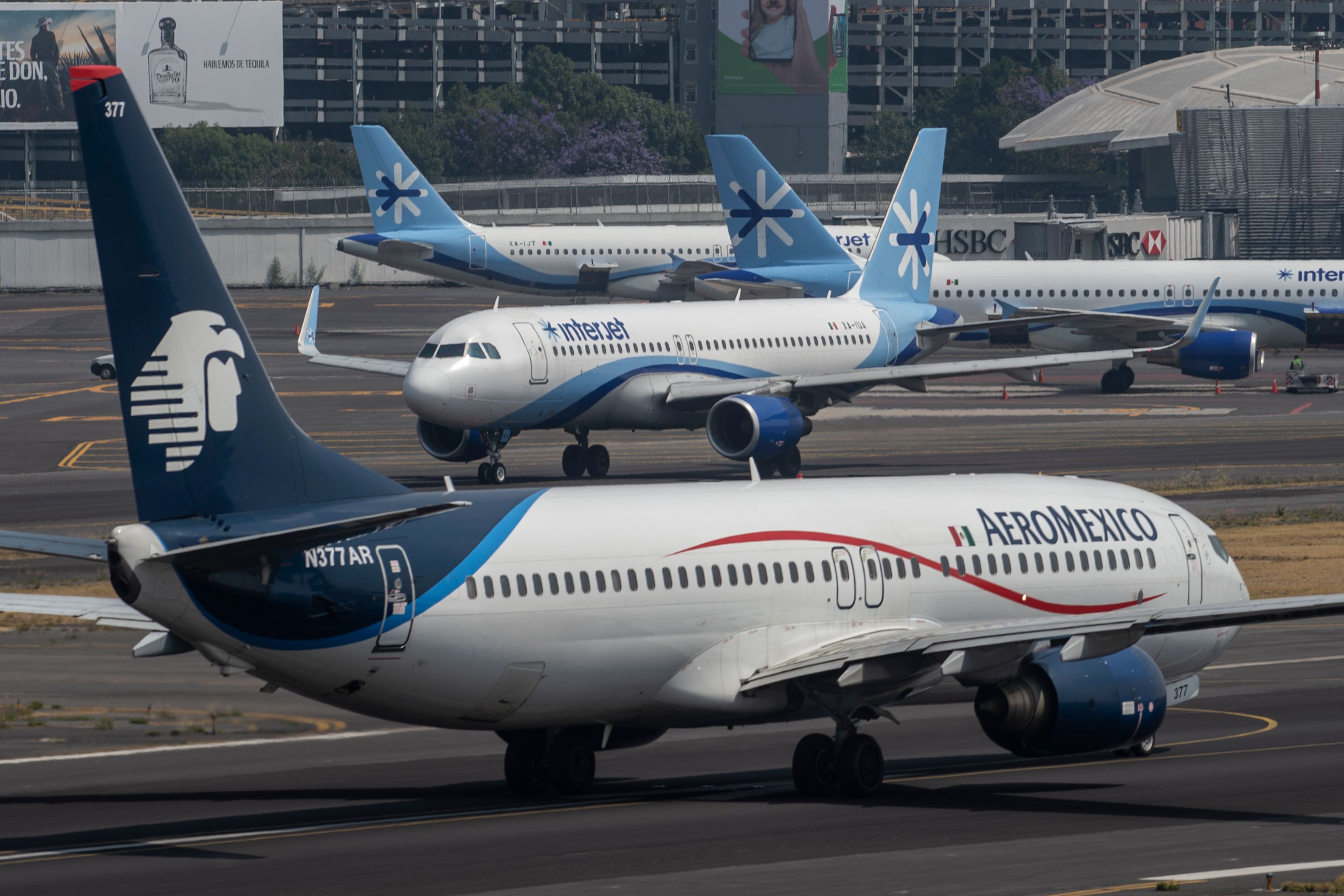 Interjet and Aeromexico planes prepare to take off at the Benito Juarez International airport, in Mexico City, on March 20, 2020. 