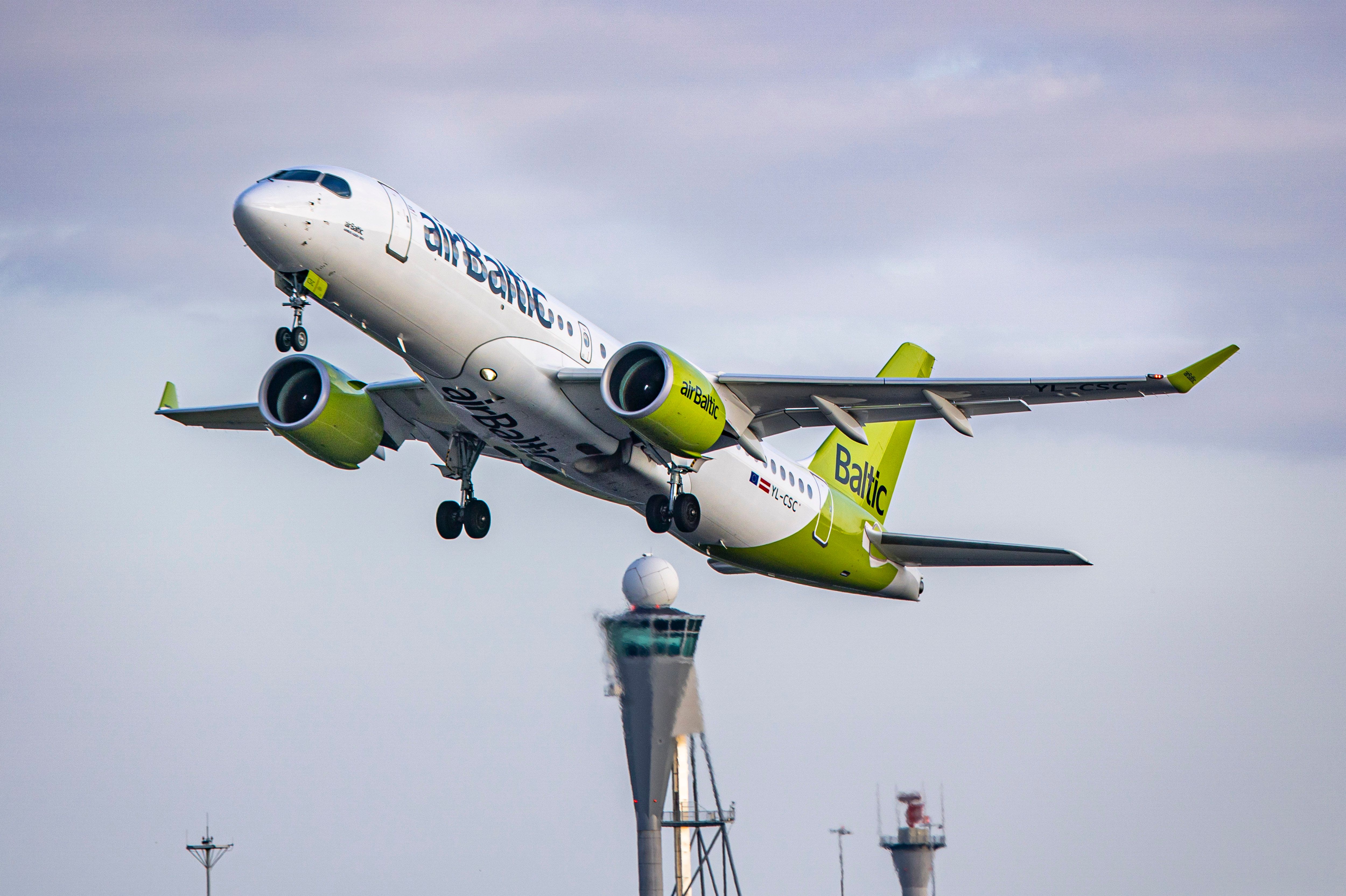 airBaltic Airbus A220-300 aircraft as seen departing from Amsterdam Schiphol Airport. 