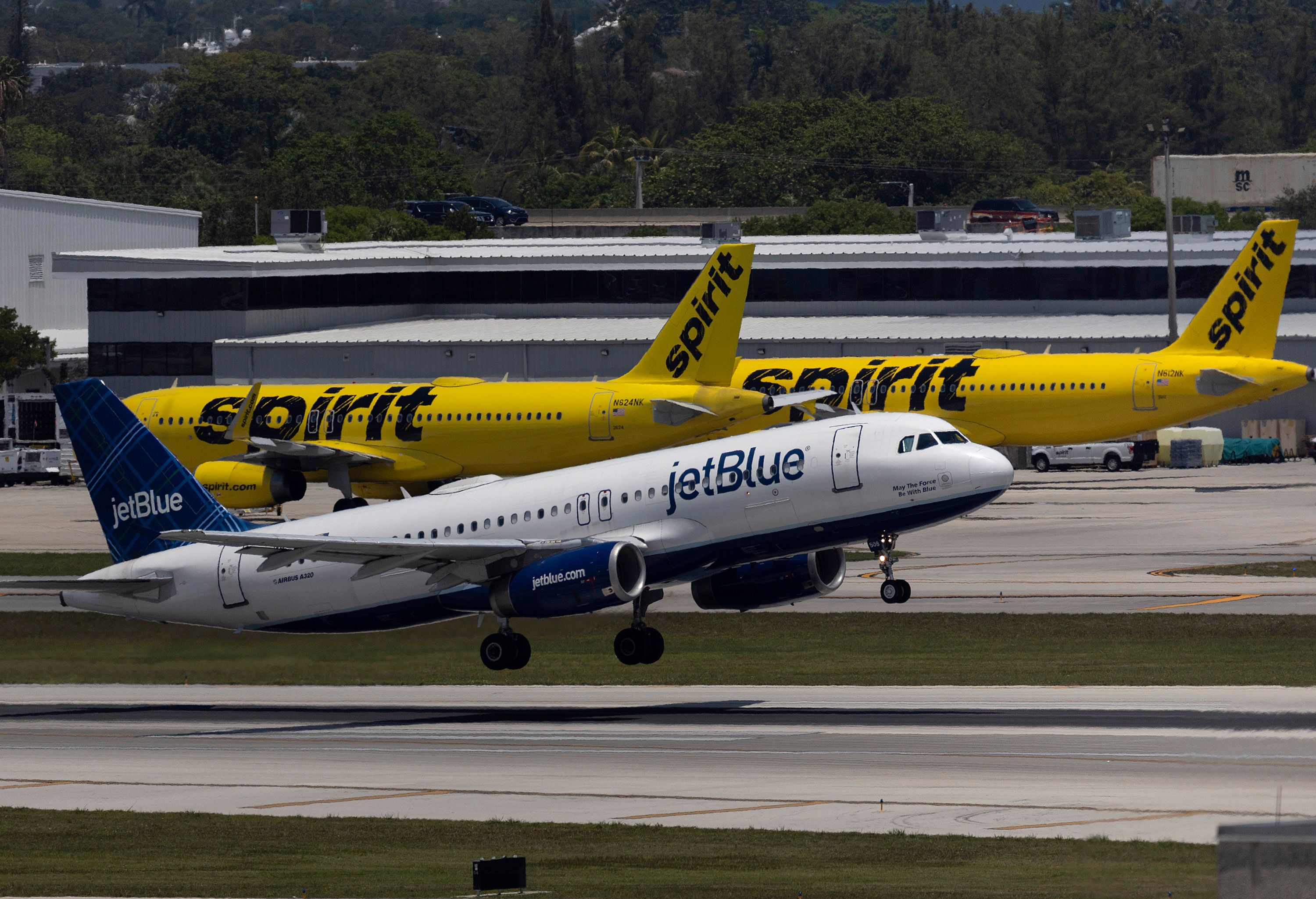 A JetBlue Airbus Takes Off From Fort Lauderdale In Front of Two Spirit Airbuses