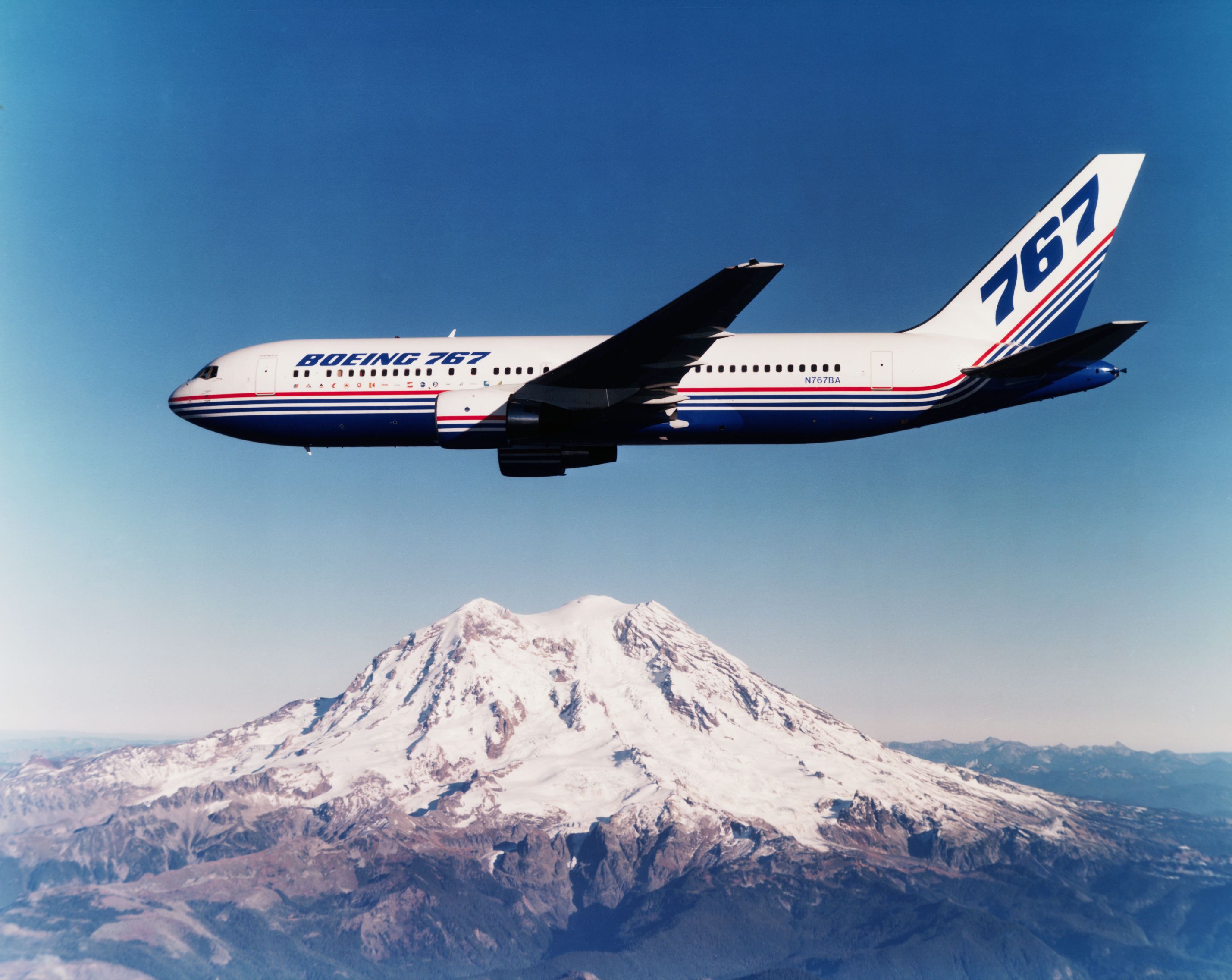 Boeing 767 in air over mountain