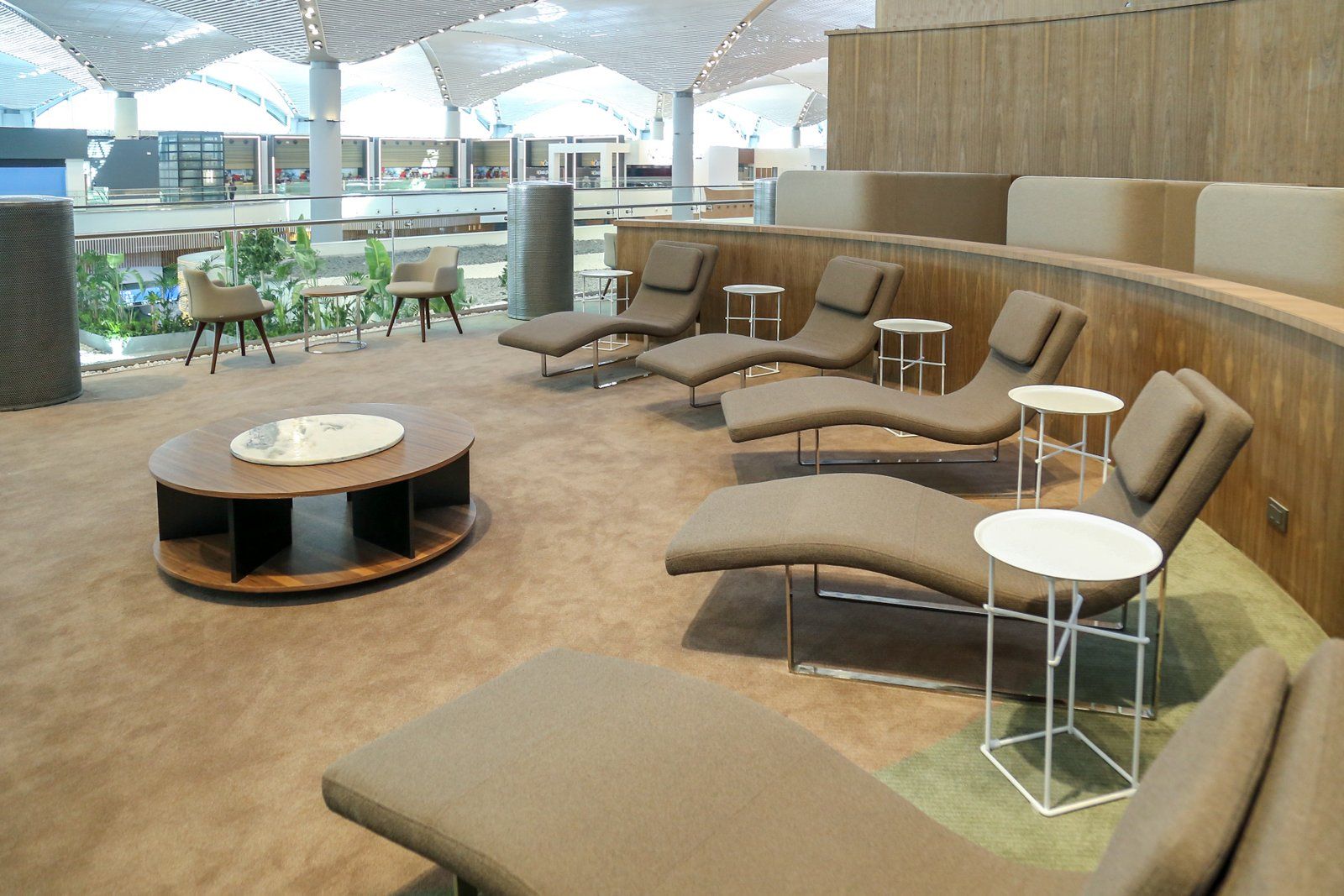 An Airport rest area with lounge chairs.