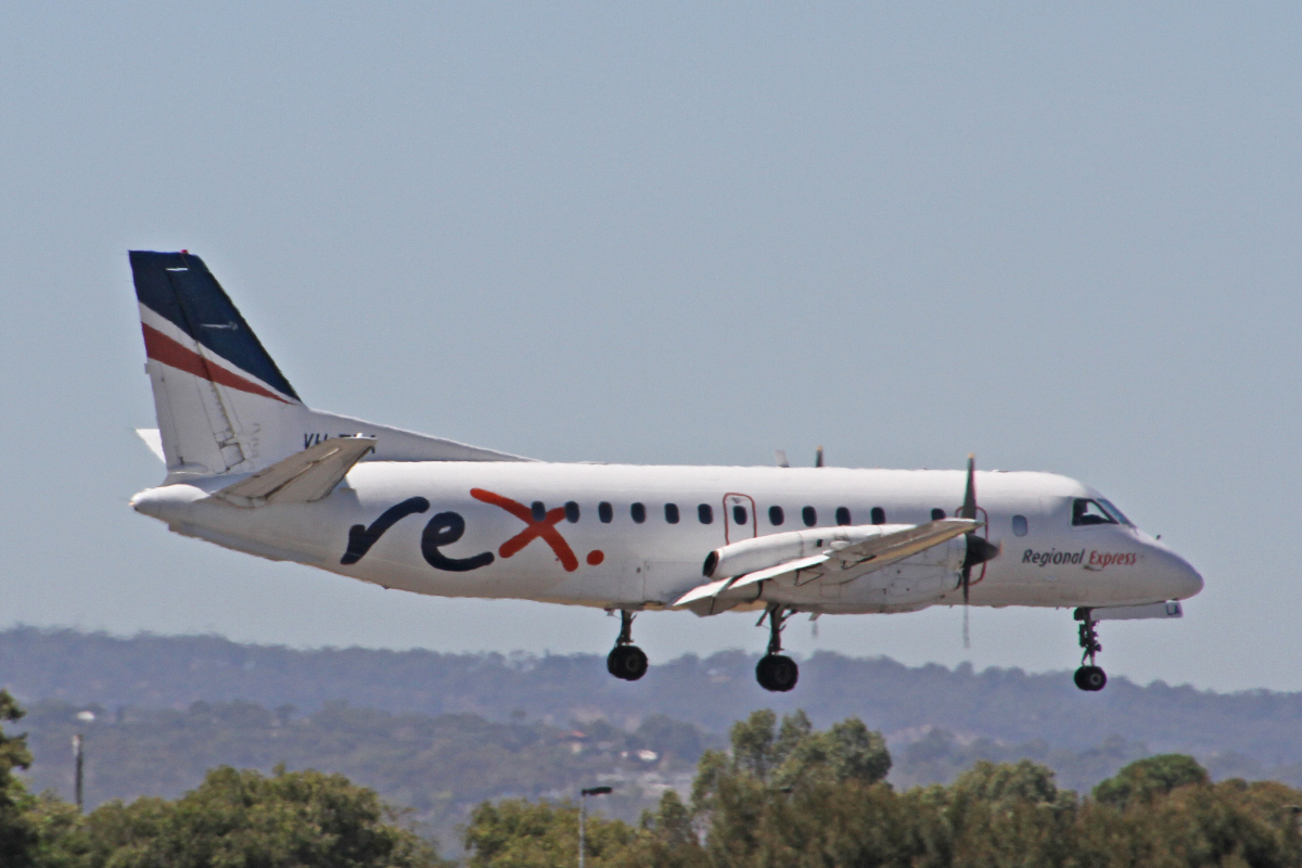 A Rex Regional Express Saab 340 Aircraft flying low to the ground.
