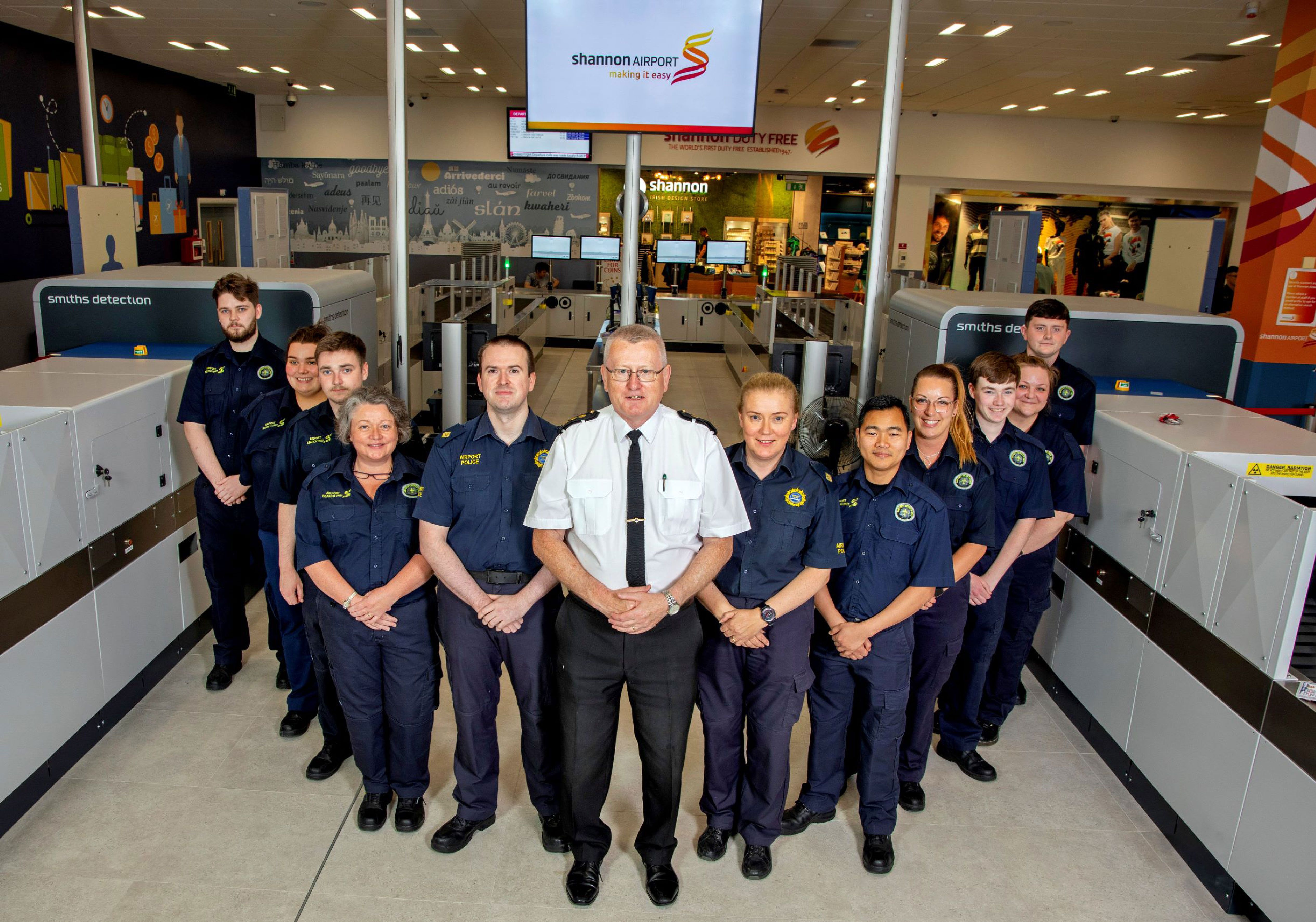 SHannon Airport security recruits in front of scanners 