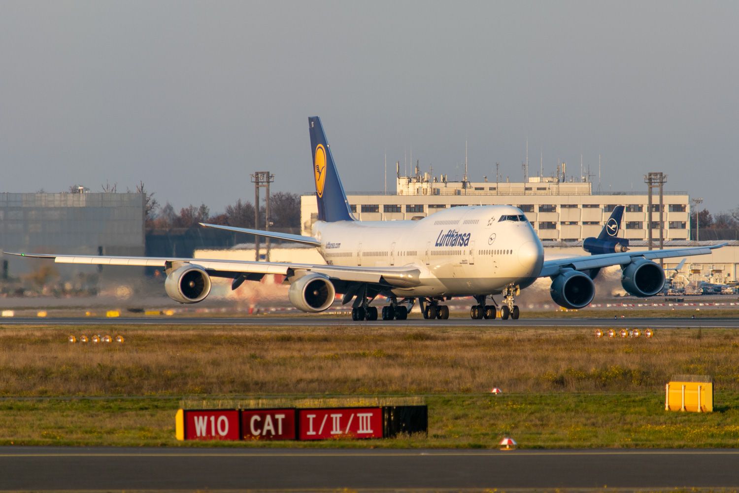 Lufthansa Boeing 747-8 Departing Frankfurt Airport on runway 18 during golden hour.