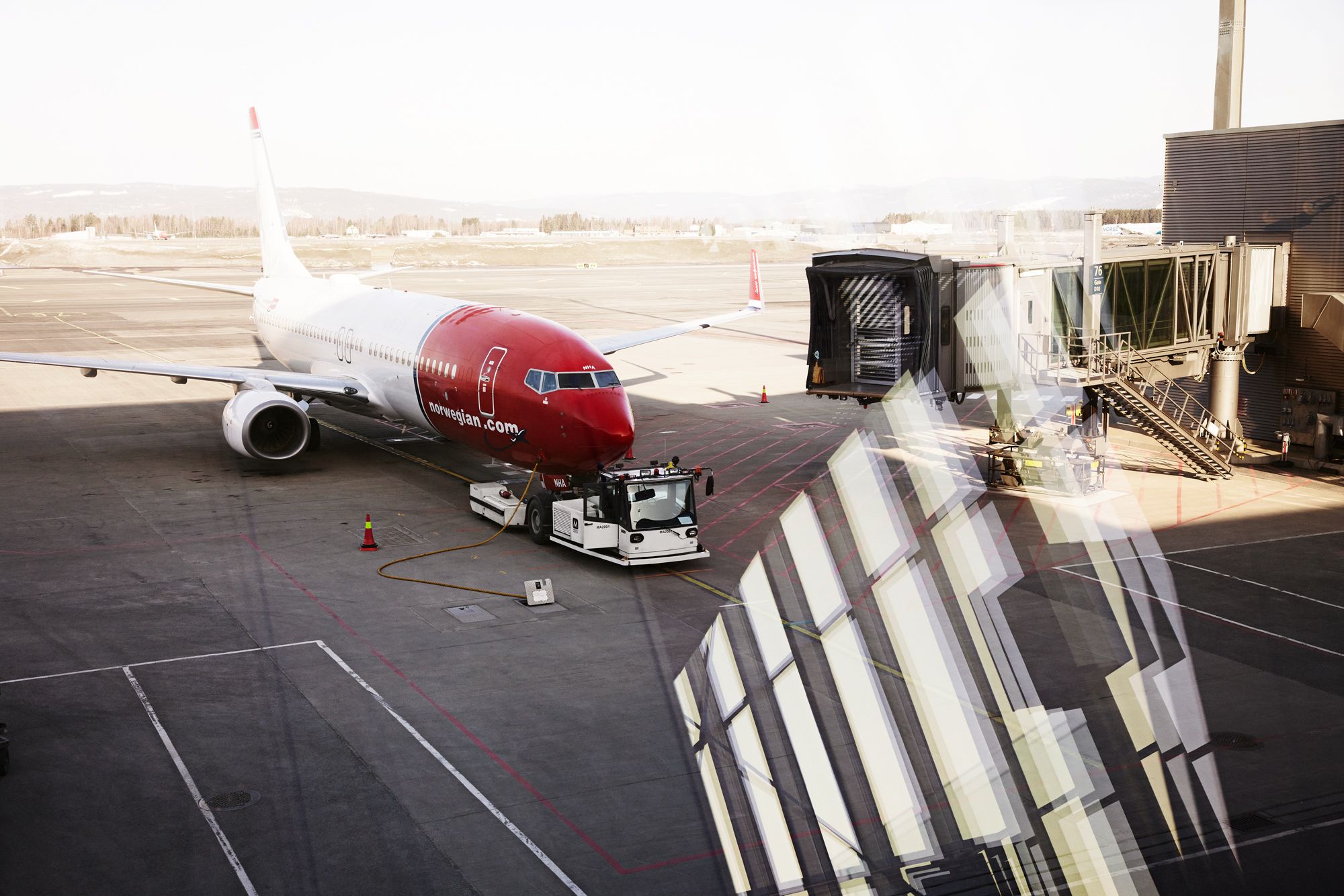 Norwegian aircraft at airport gate