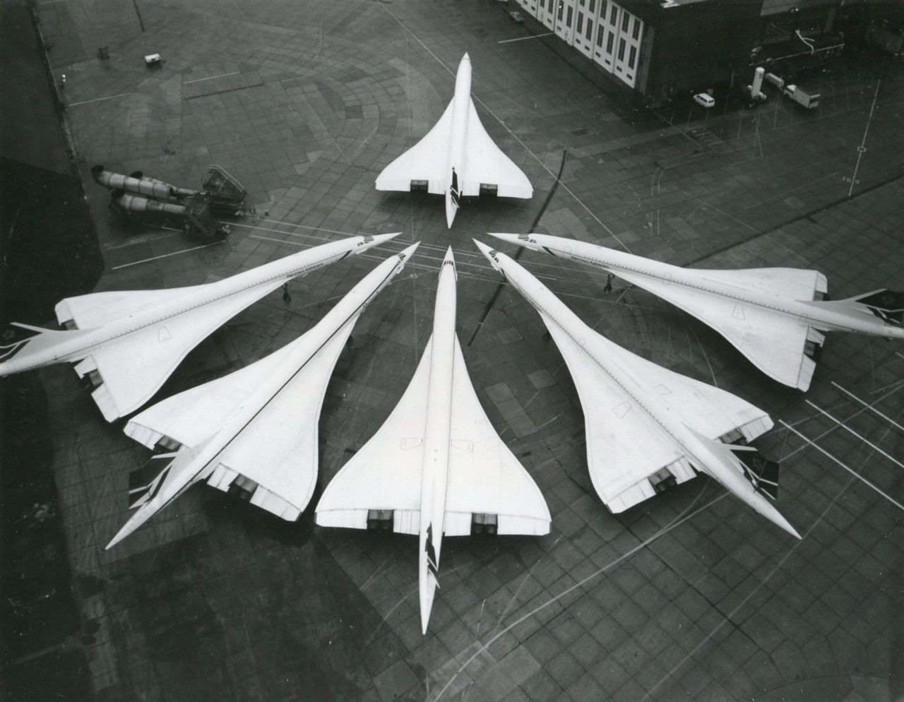 6 British Airways Concordes parked side by side.