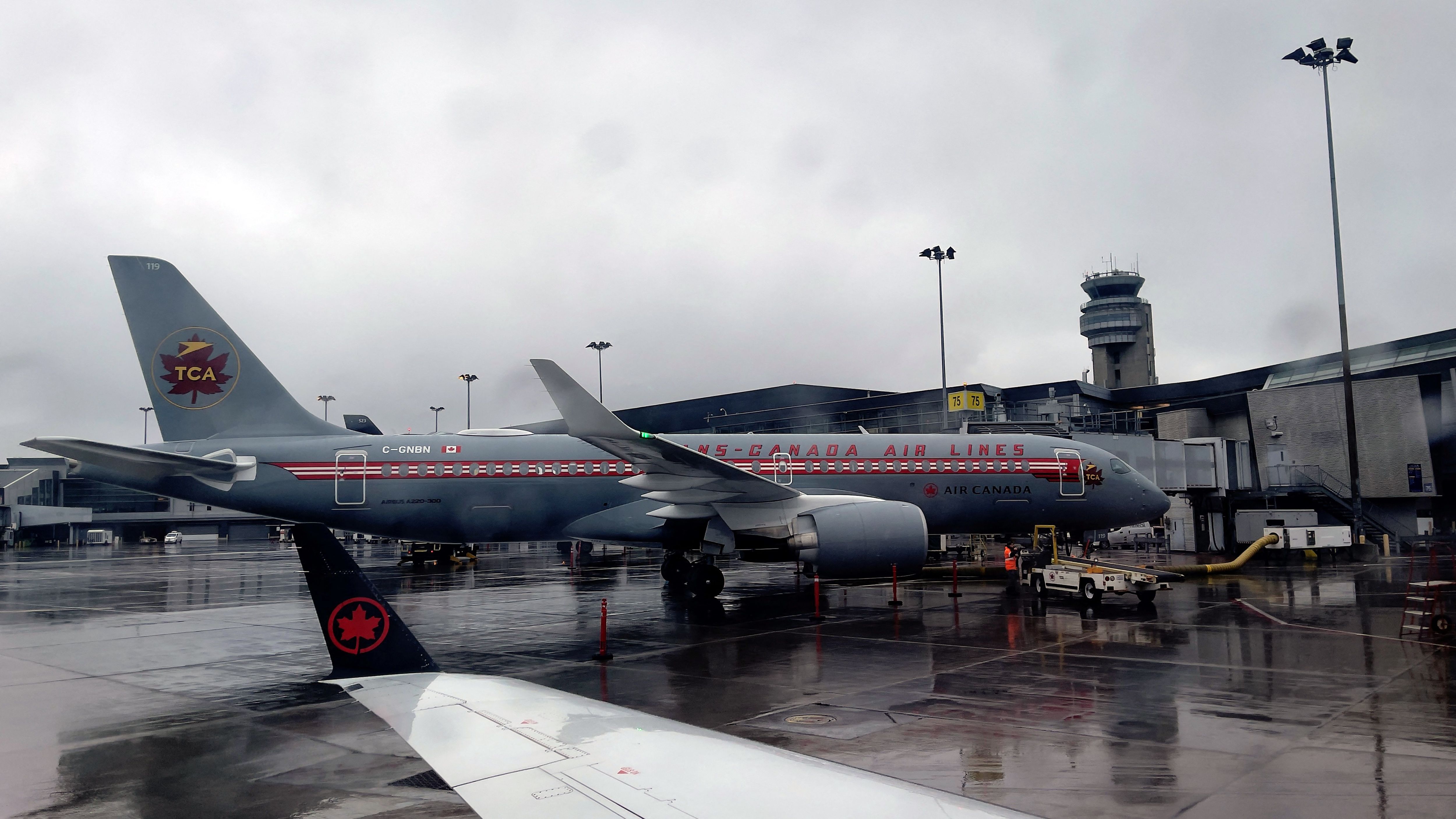 Air Canada plane in retro livery parked at gate at Montreal airport 