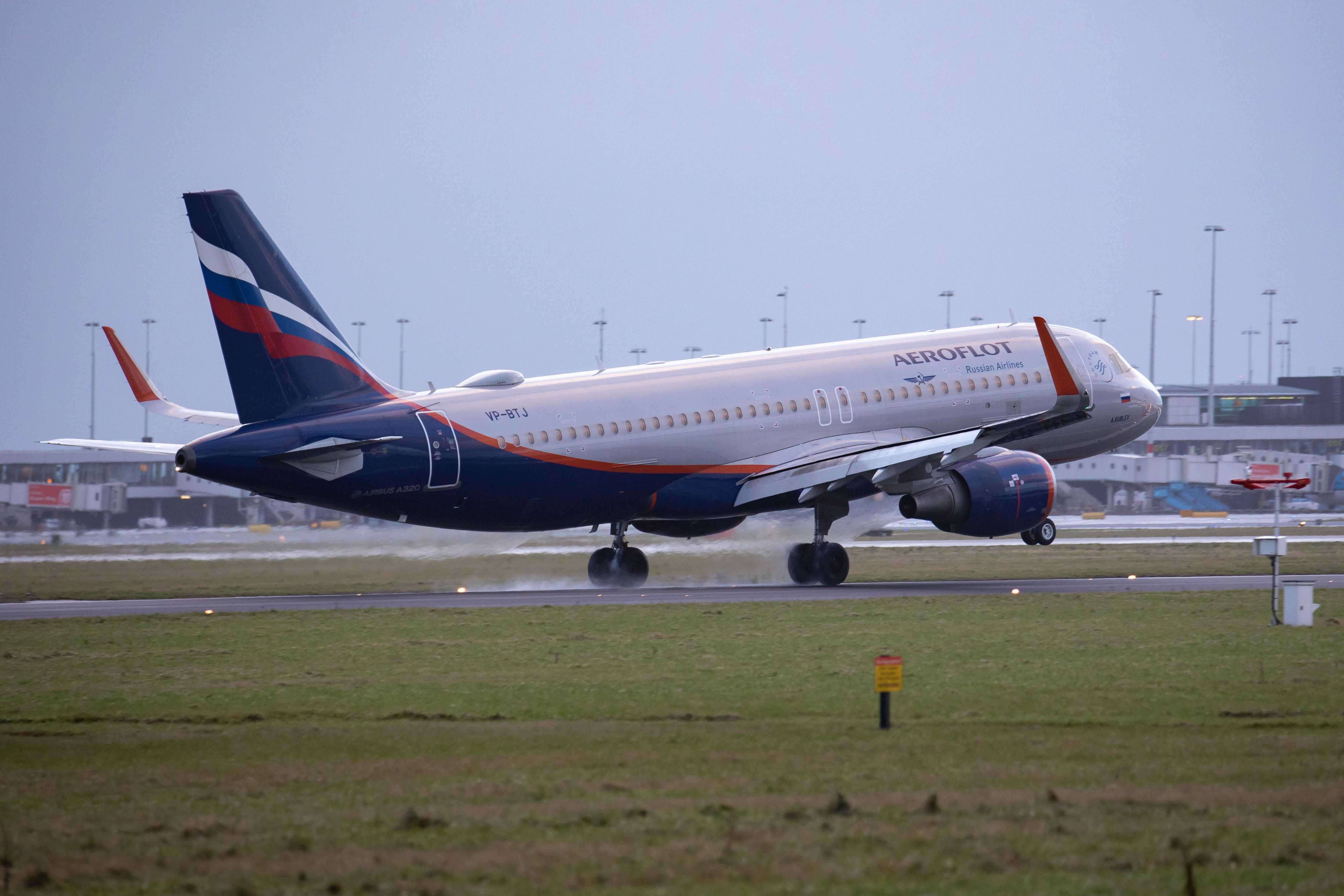 An Aeroflot - Russian Airlines Airbus A320 aircraft as seen on final approach flying and landing on the runway at Amsterdam Schiphol Airport