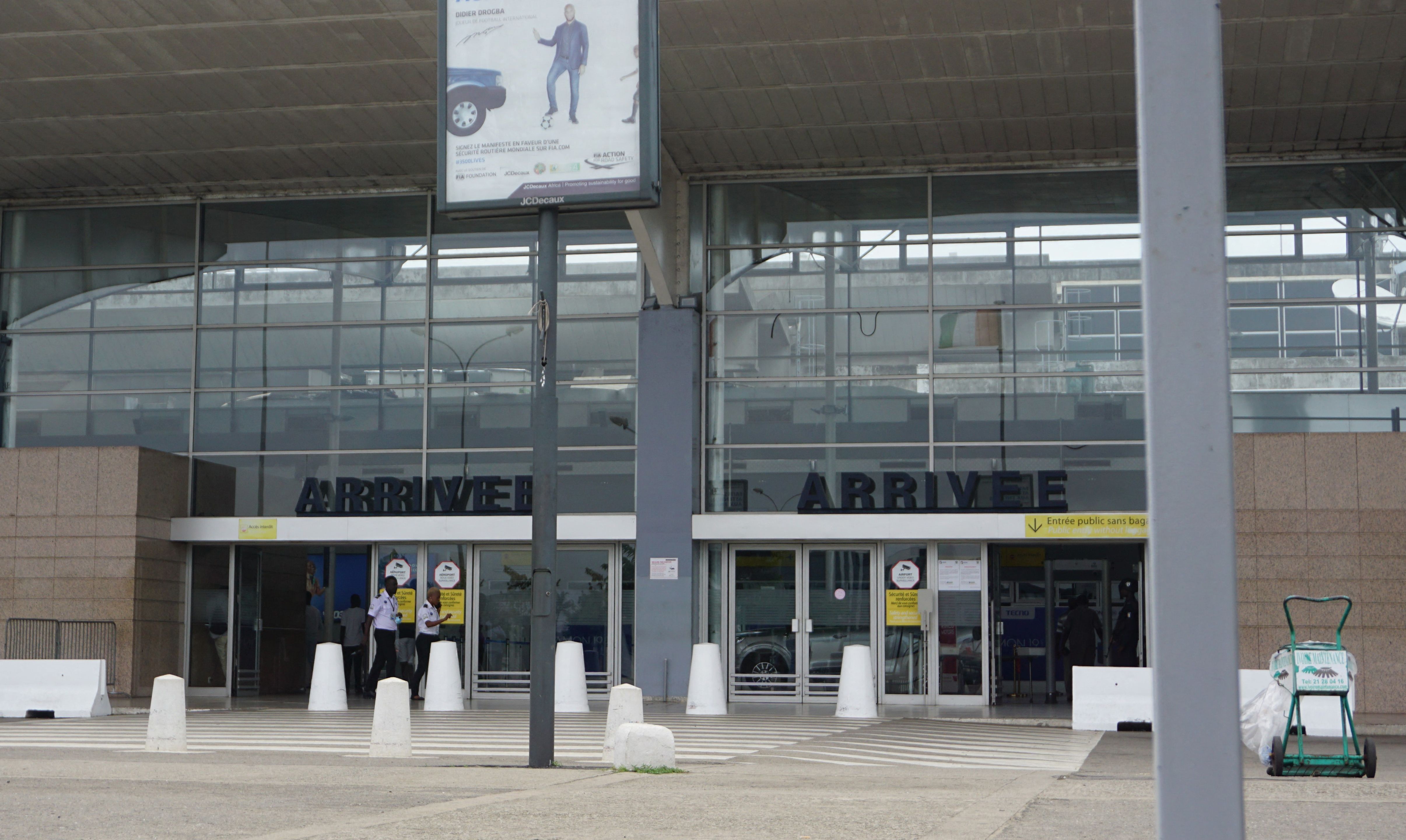 Airport staff walk past an empty arrivals hall outside the Felix Houphouet Boigny International airport in Abidjan on September 24, 2022, after a strike by air traffic controllers, that started Friday, paralysed serval West African airports with all commercial flights cancelled. 