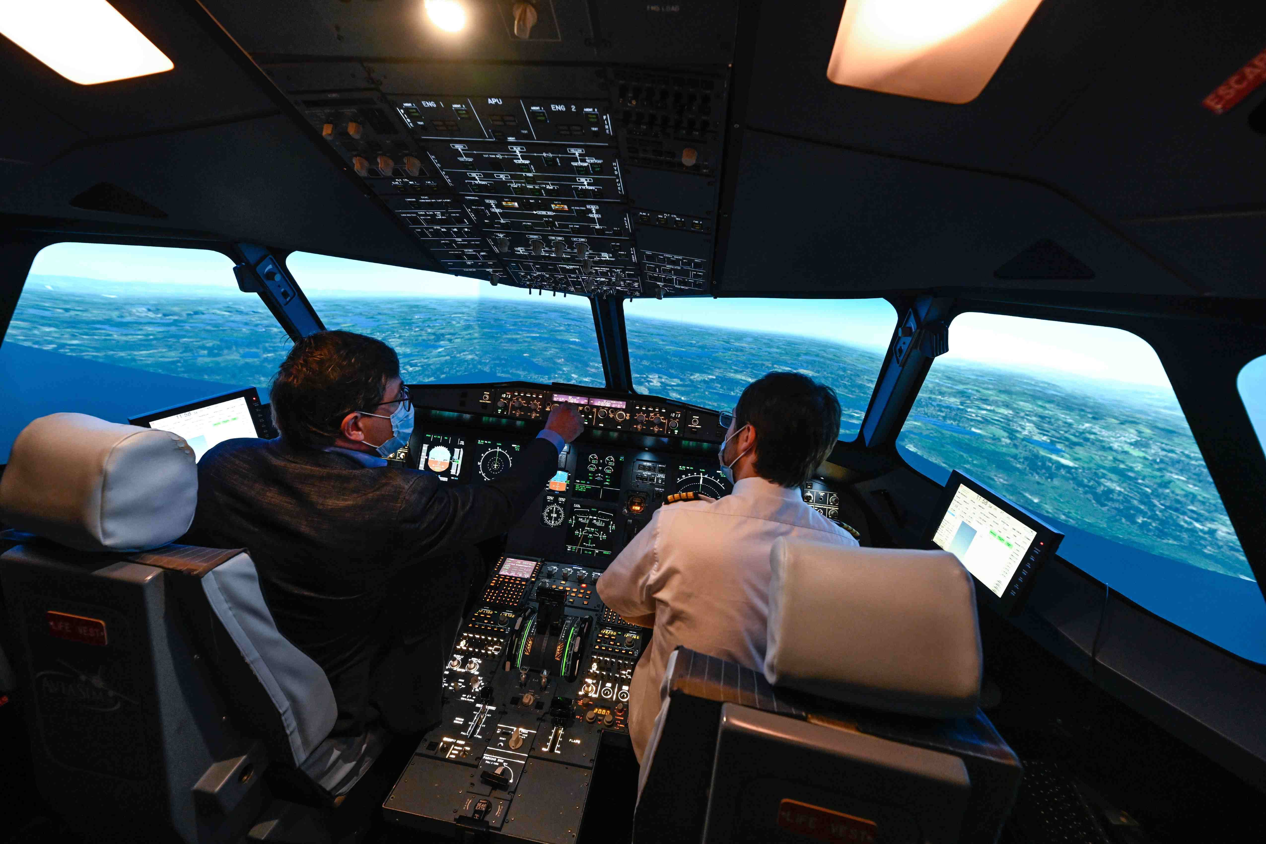 Pilots in flight training simulator