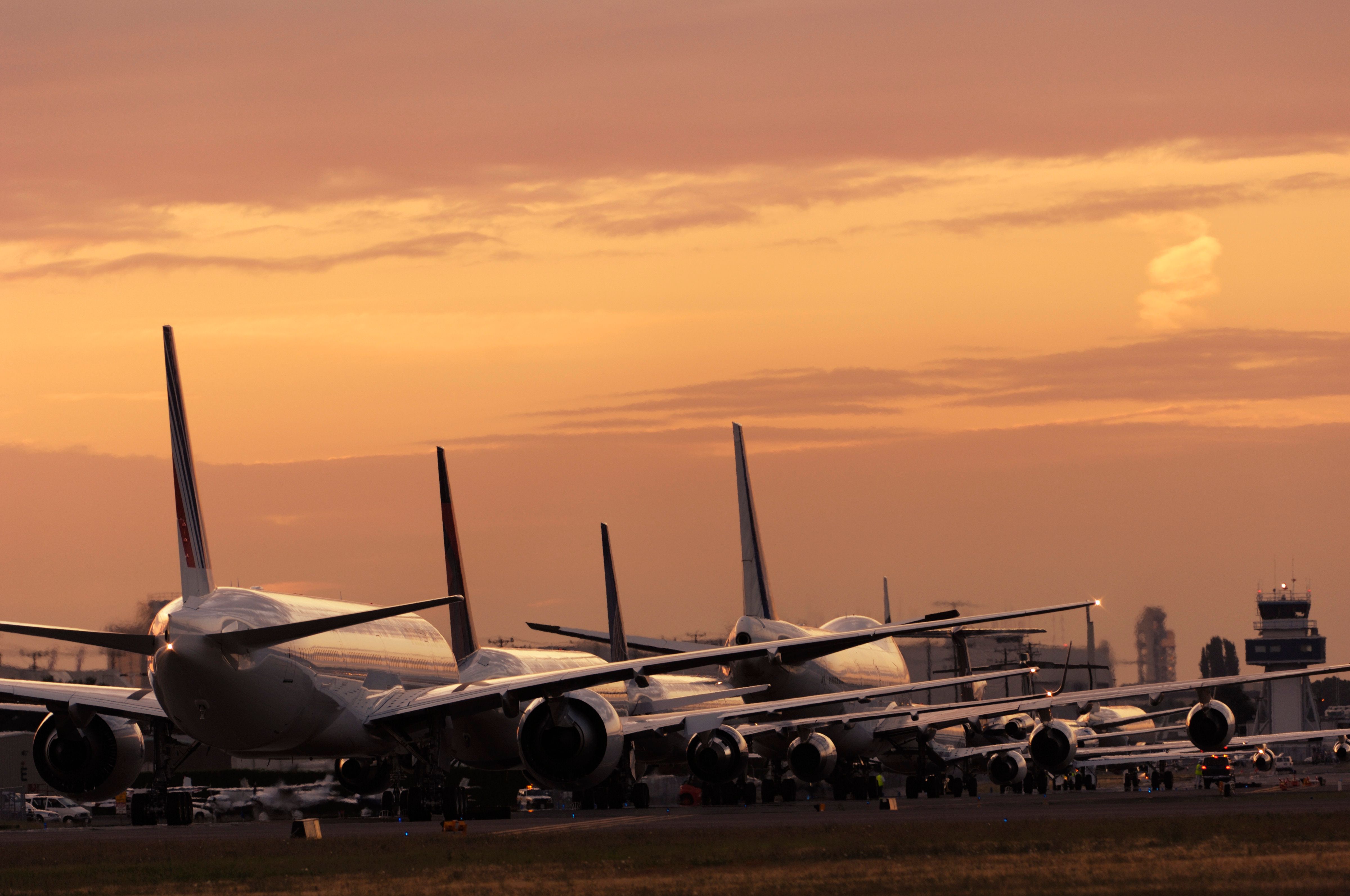 Several Boeing jets lined up at sunset
