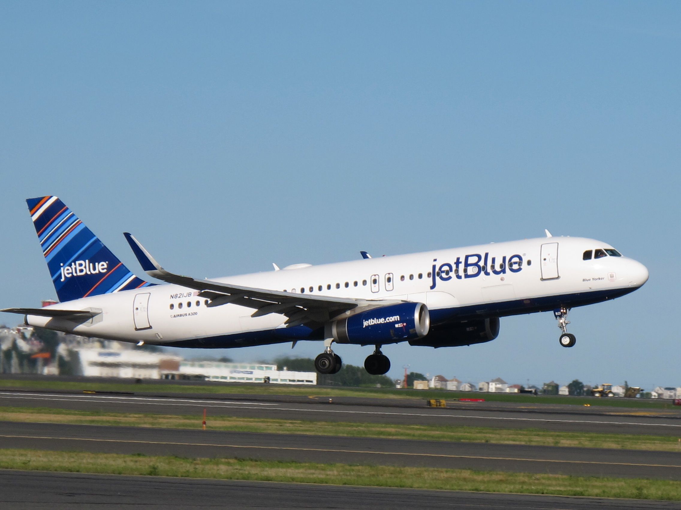 A JetBlue-branded Airbus aircraft taking off