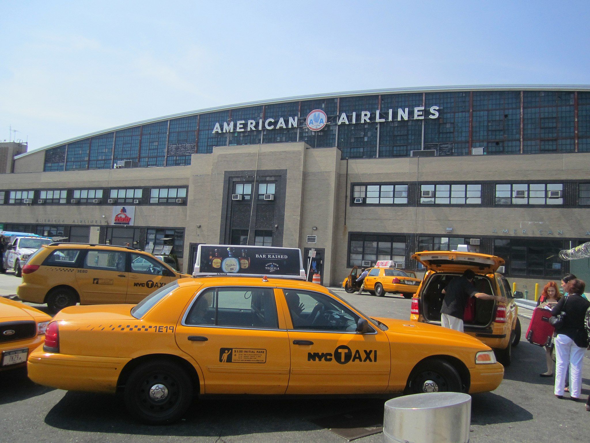 A group of yellow taxis outside the American Airlines terminal at LaGuardia Airport