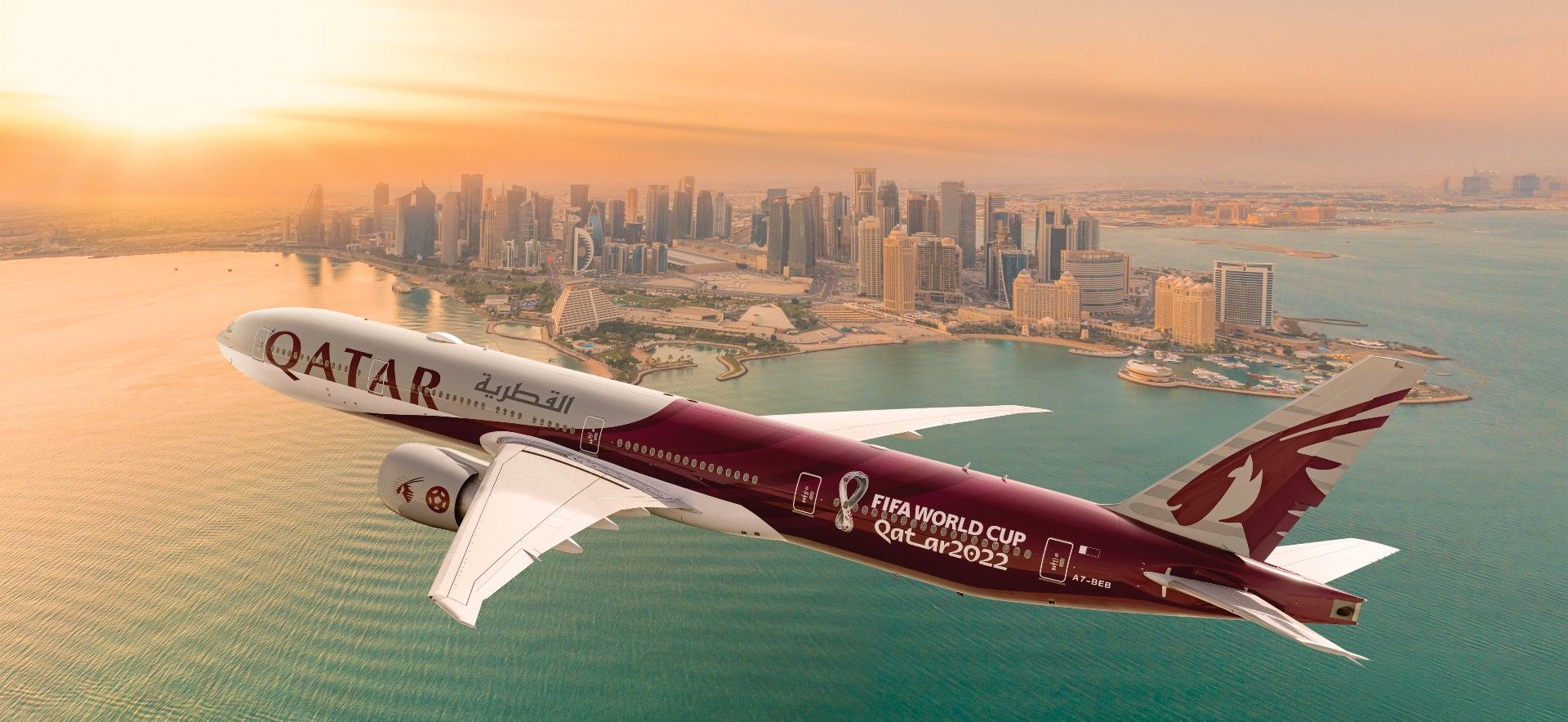 A Qatar Airways Boeing 777 wearing the 2022 FIFA World Cup livery is seen flying over the city.