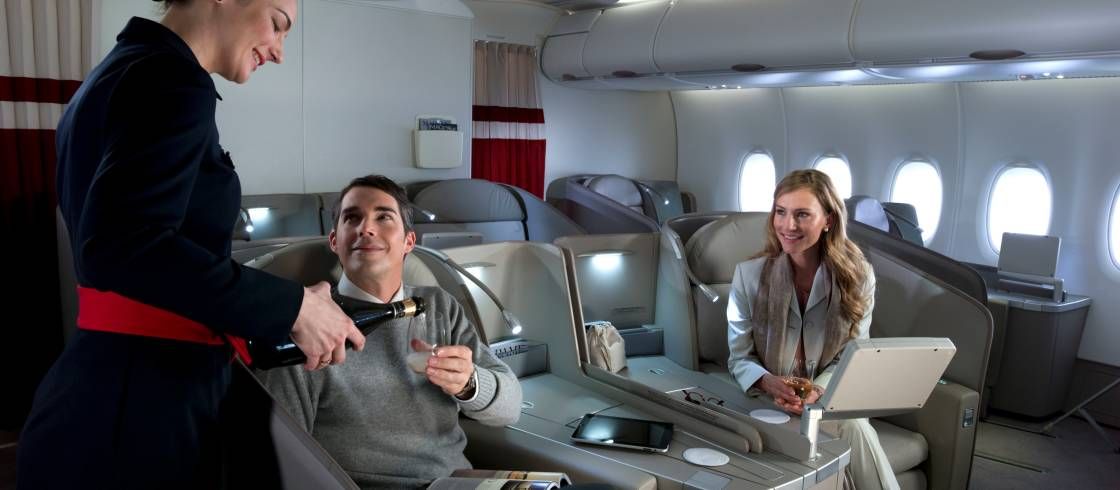 Passengers being served Champagne onboard Air France's La Premiere cabin.