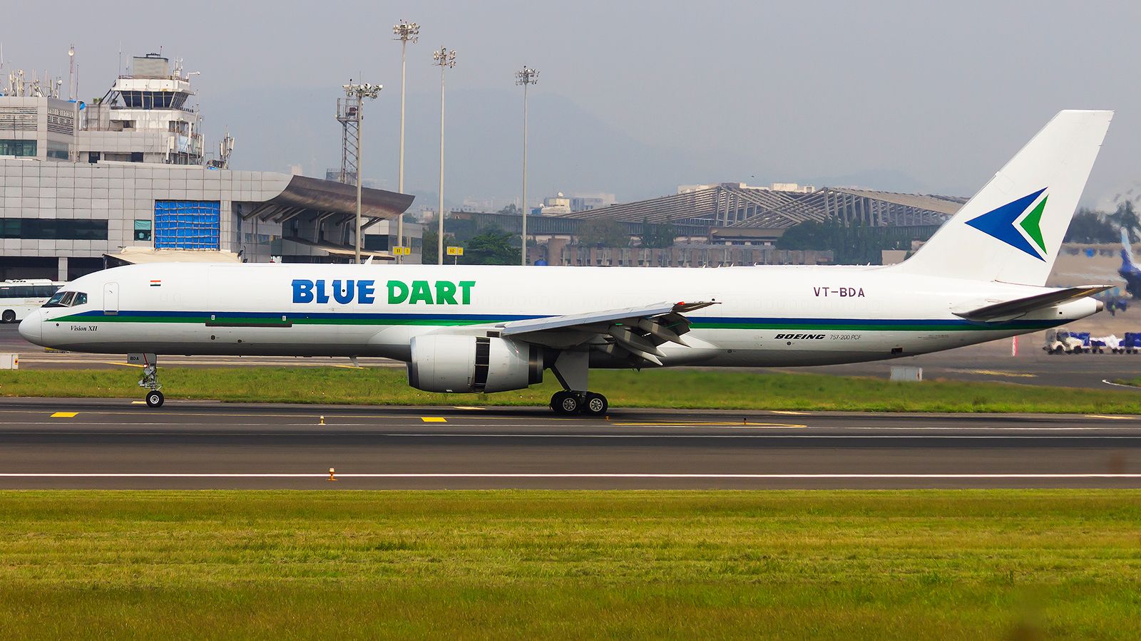 A Blue Dart Boeing 757 freighter rolling down the runway.