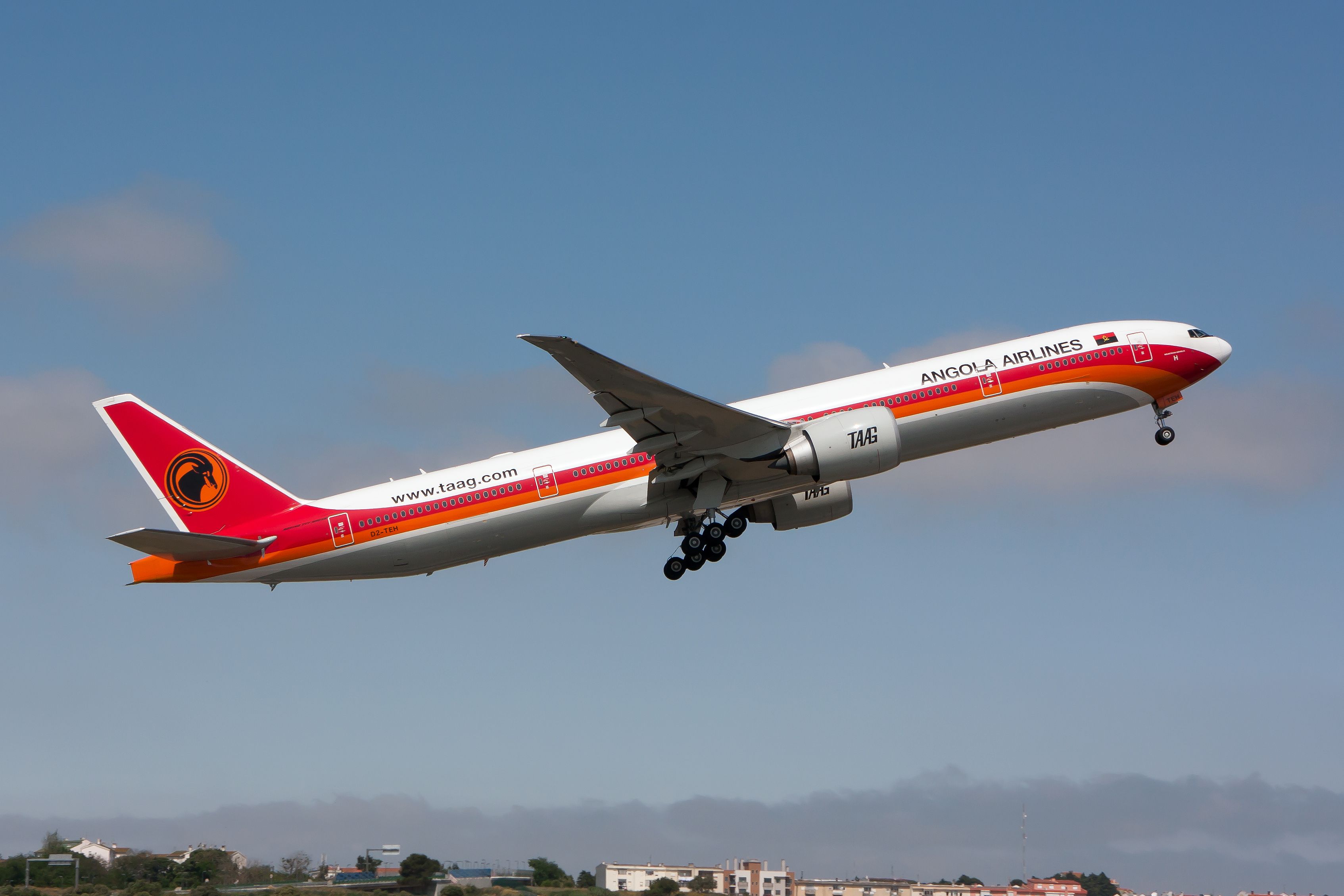 A TAAG Linhas Aéreas de Angola Boeing 777-300ER takes off from Lisbon Delgado airport