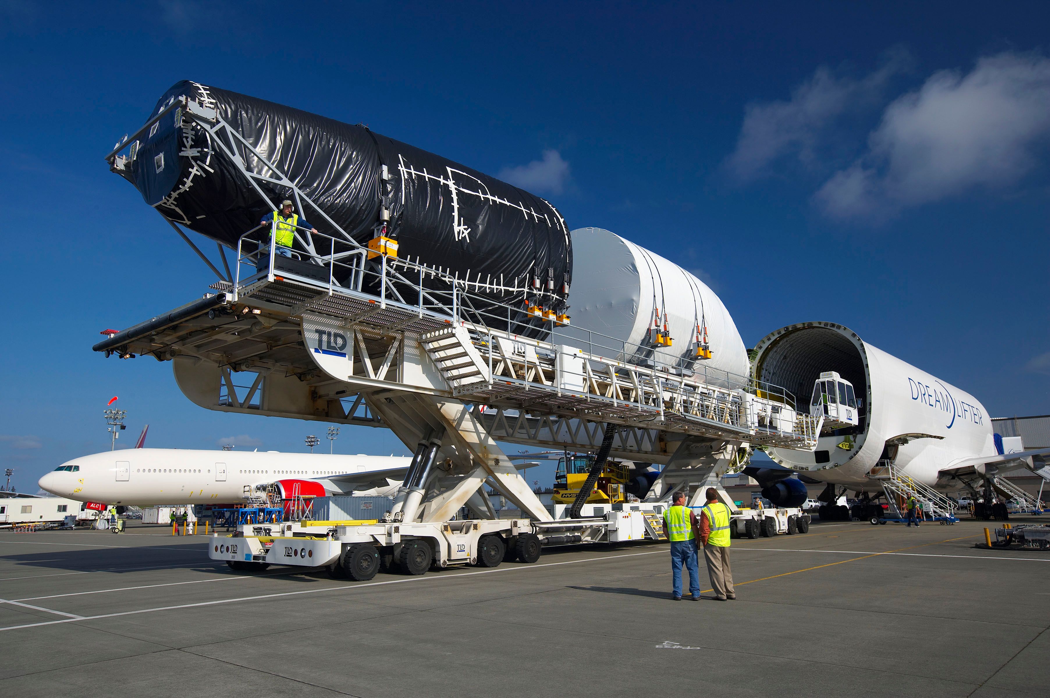 A Boeing 787 fuselage being loaded into a Boeing Dreamlifter.