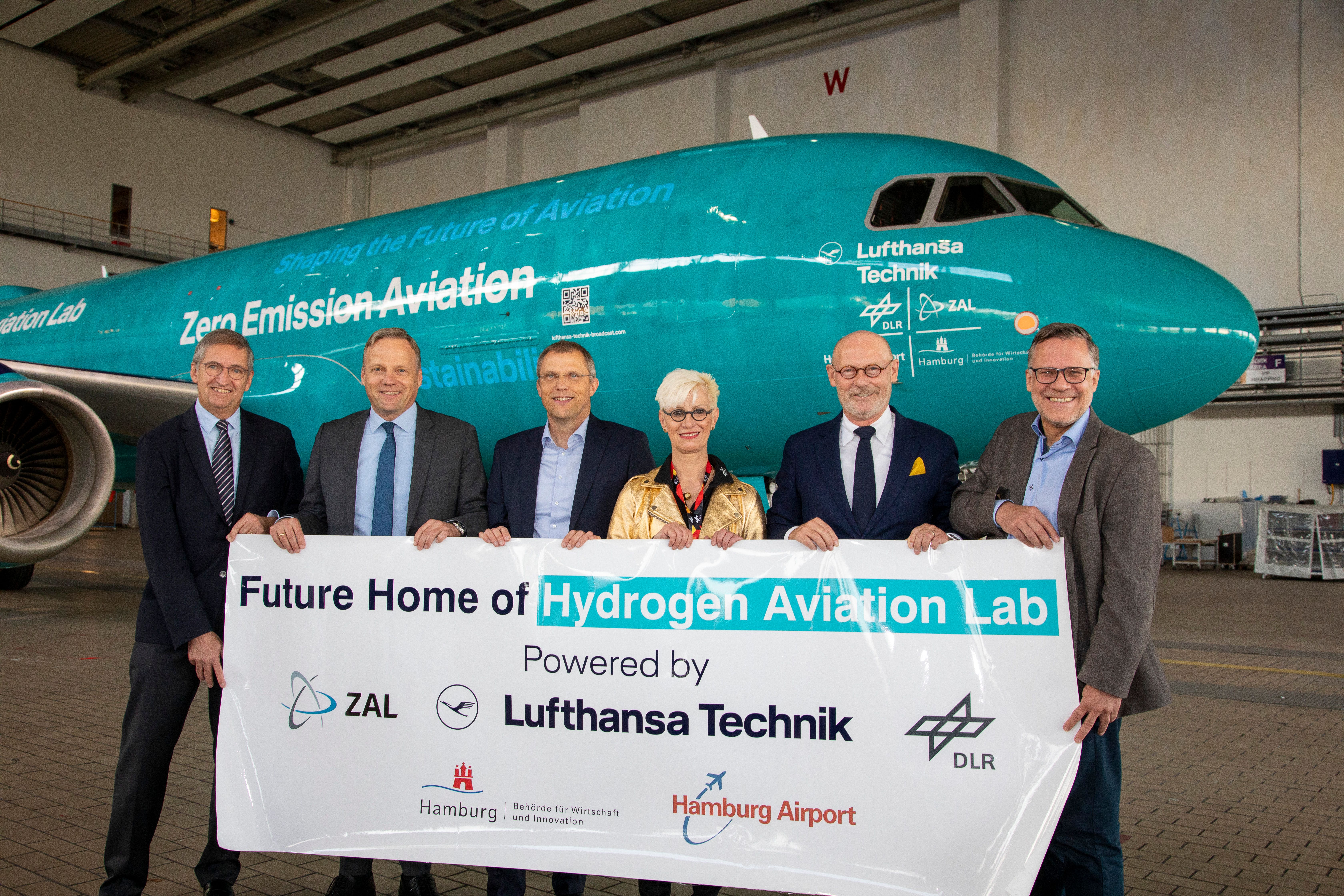 image of delegates from joint project in front of hydrogen lab aircraft 