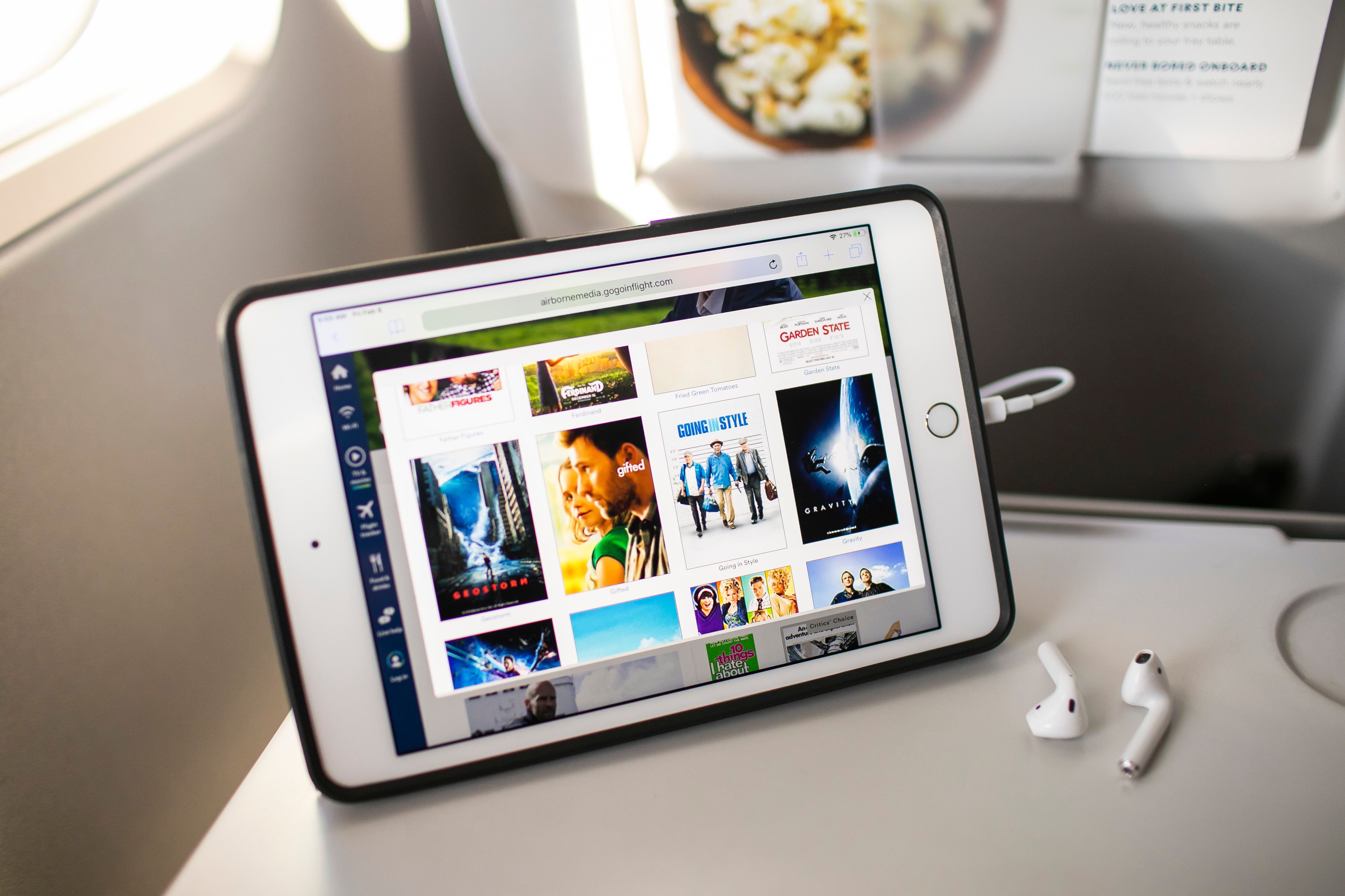 Alaska Airlines iPad with movies and earbuds