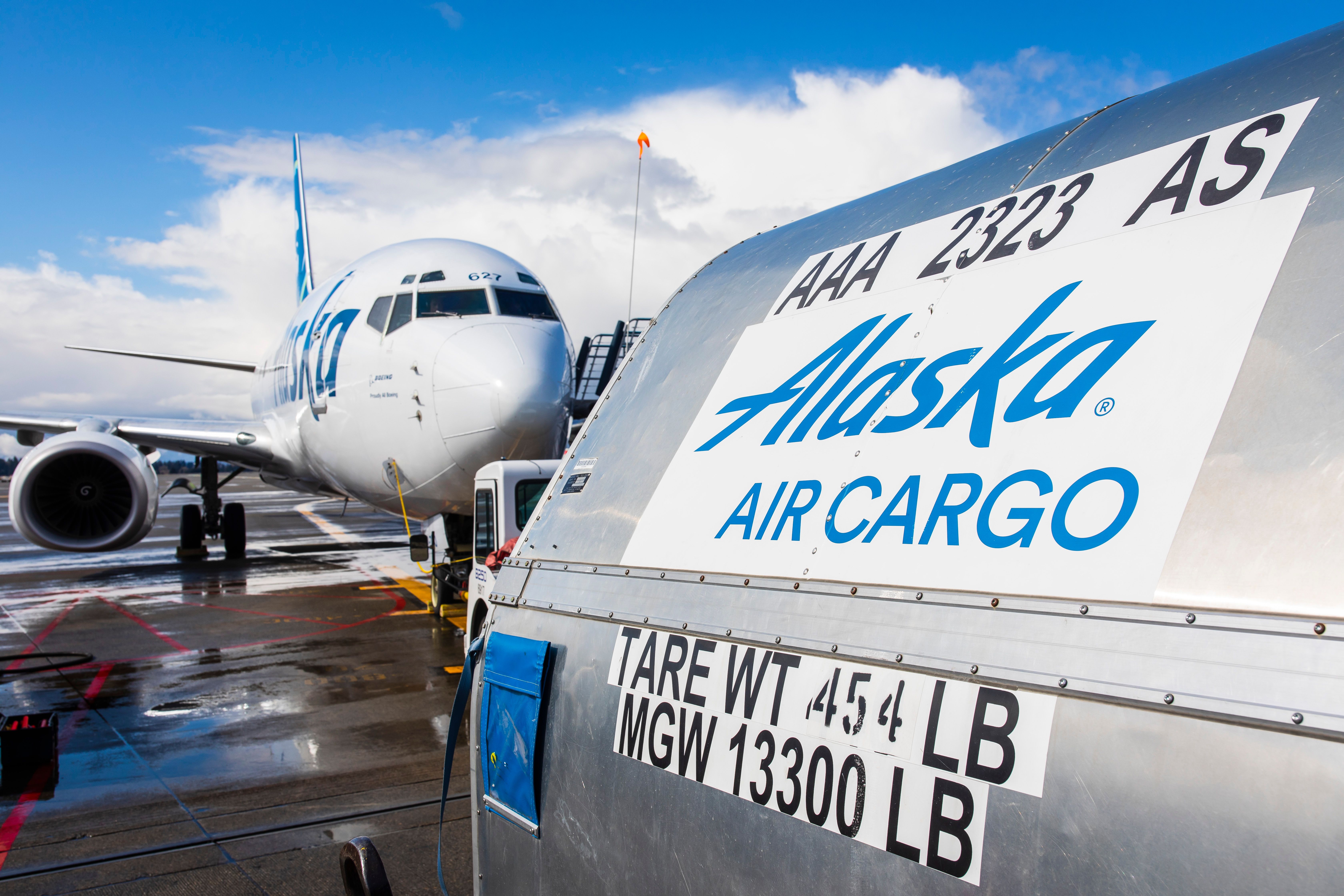 Alaska Airlines Cargo Shipment container in front of aircraft