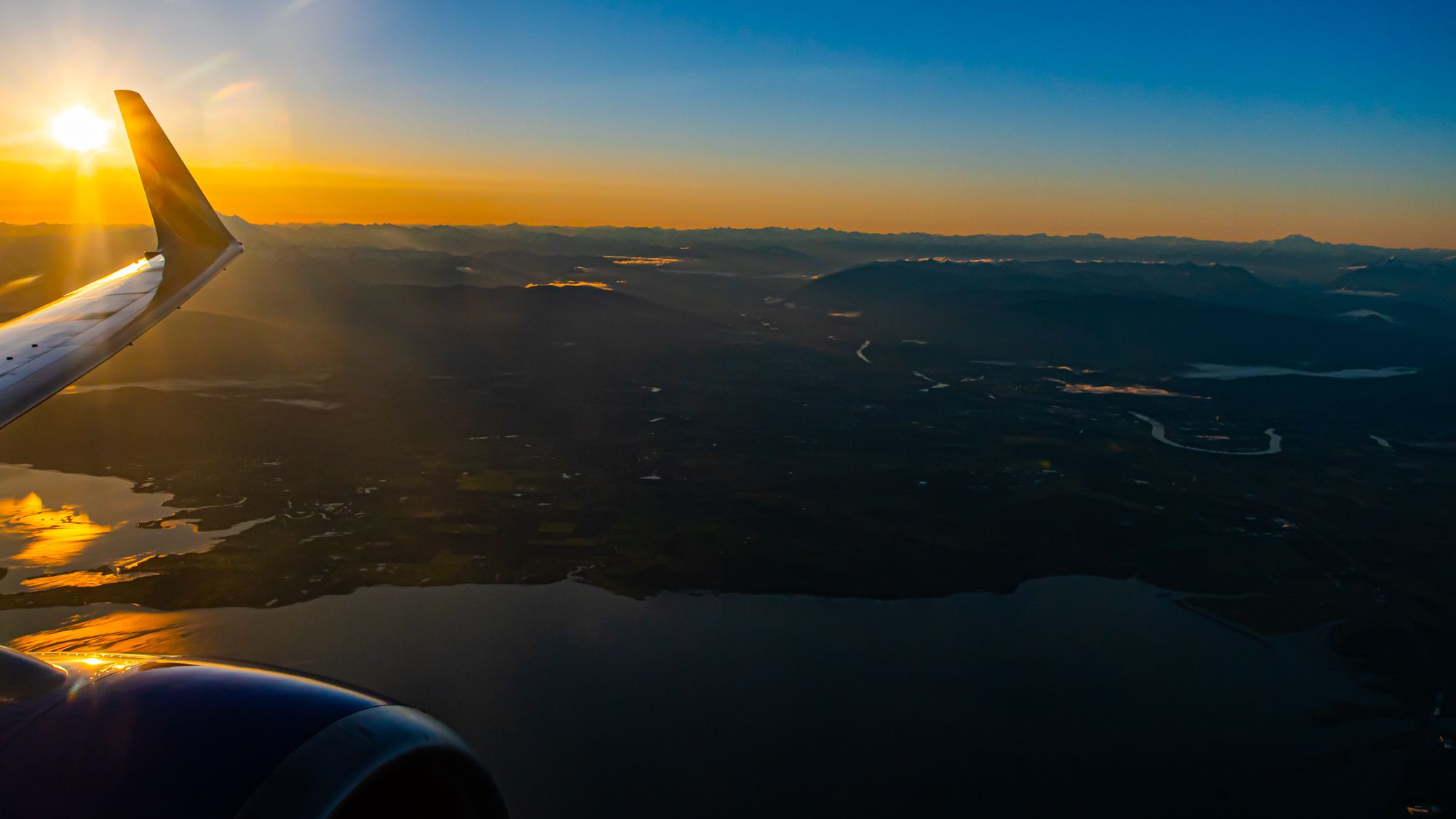 Soaring at Sunrise - A Look Back at a Boeing 737-700 Wing Looking Over Skagit County