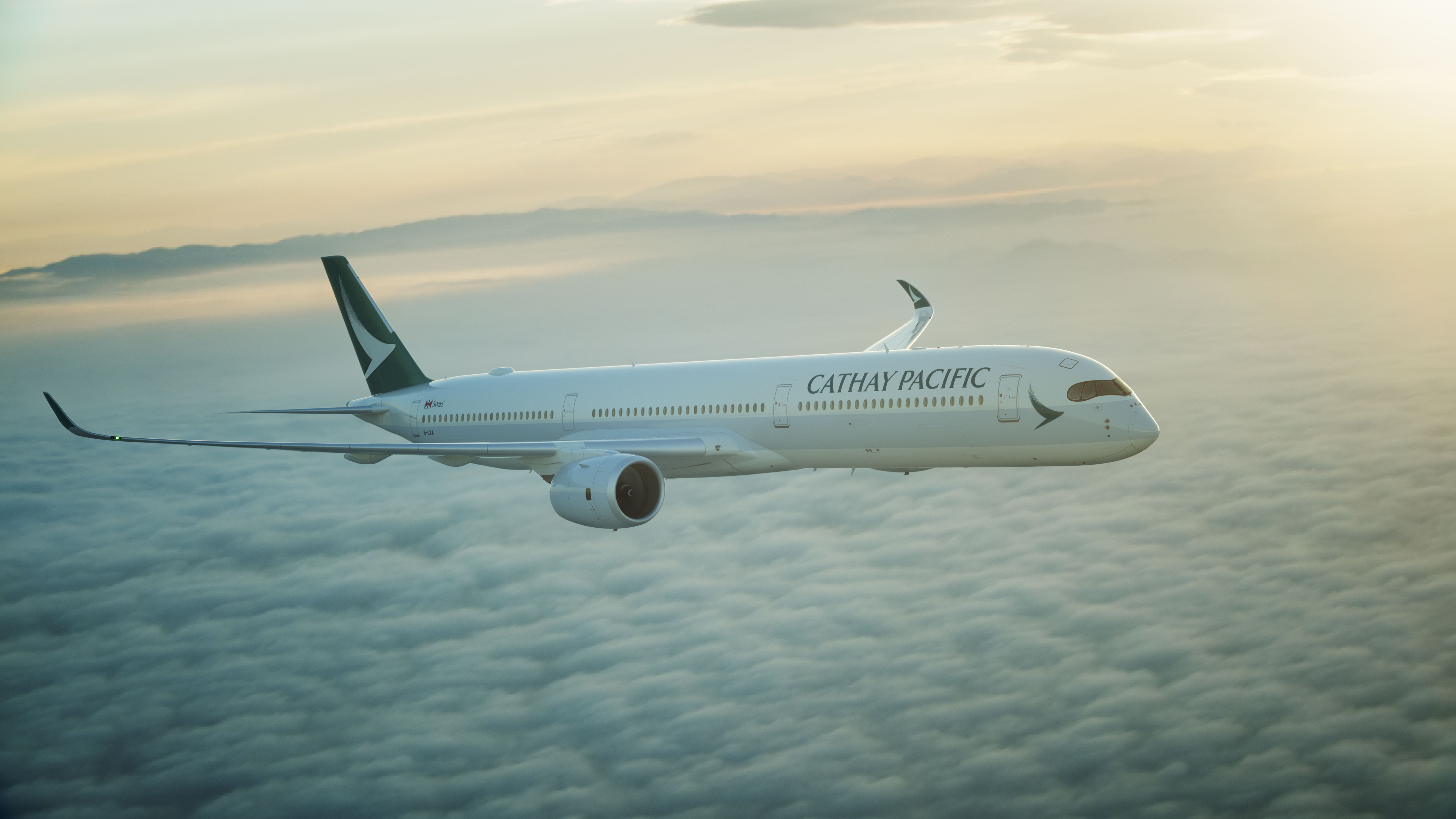 Cathay Pacific's new A350-1000 jet flying over a bed of clouds. 