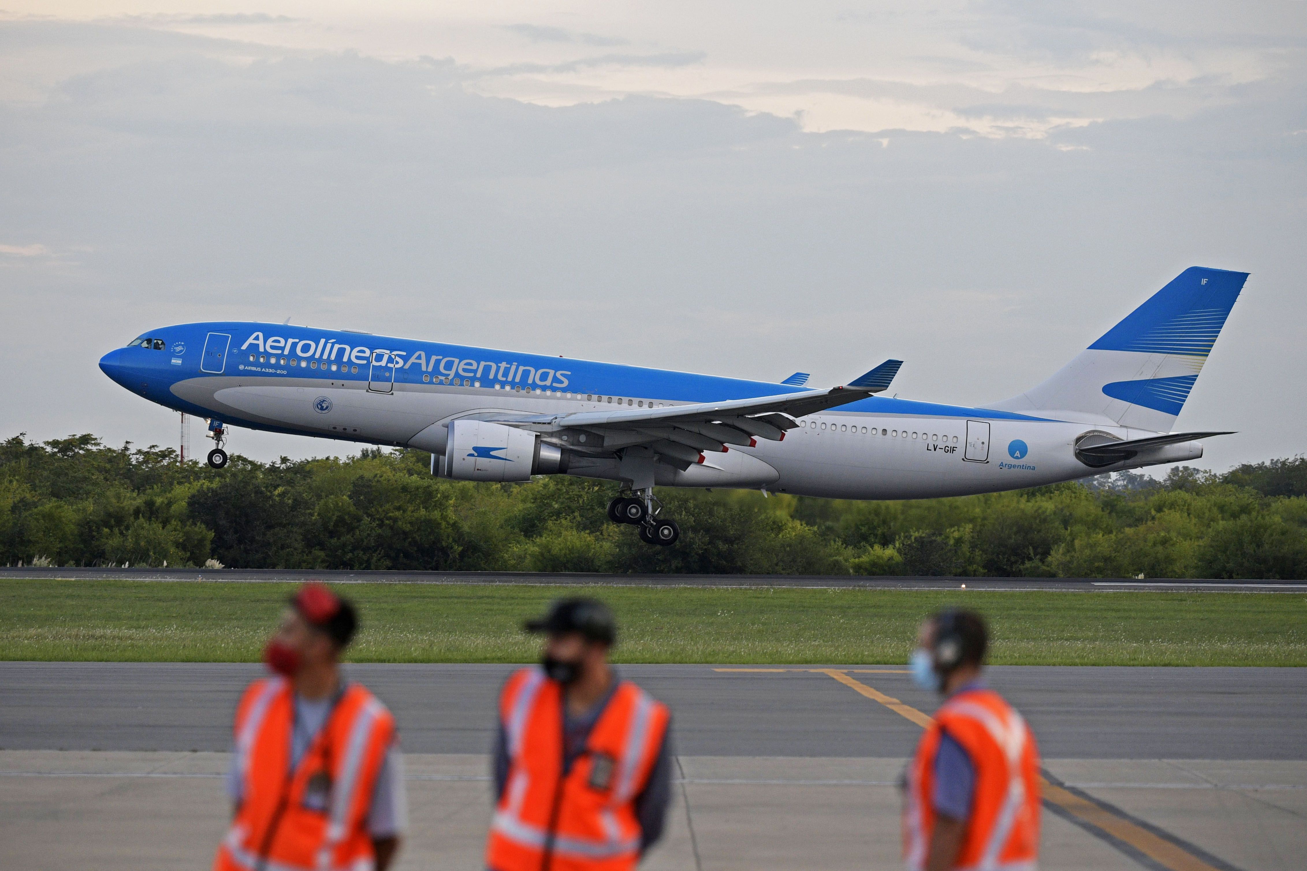 An Aerolineas Argentinas airplane carrying a container with Sputnik V vaccine doses against COVID-19, lands at the Ezeiza International Airport in Buenos Aires