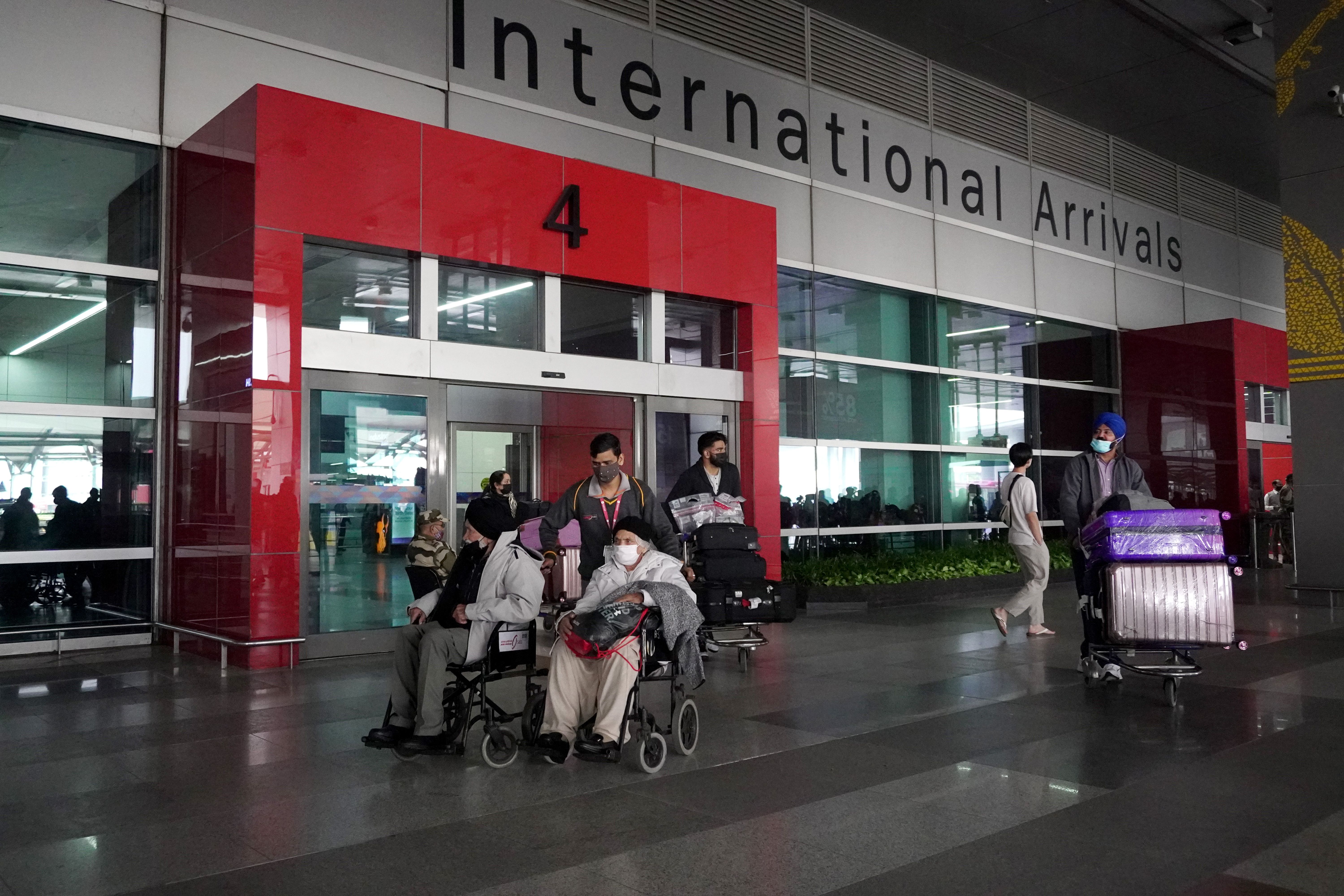 Passengers exit from the arrivals area for international travellers at Delhi Airport