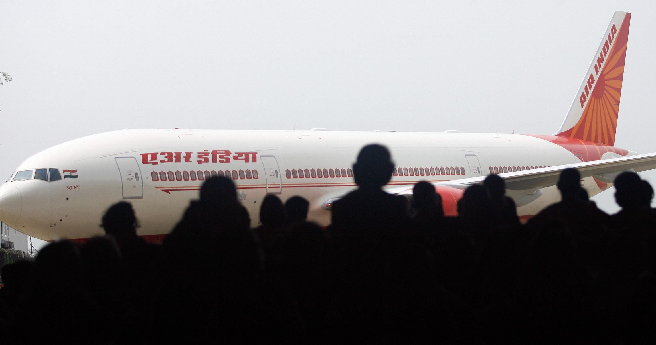 Air India employees look at the newly acquired Boeing 777-200LR aircraft