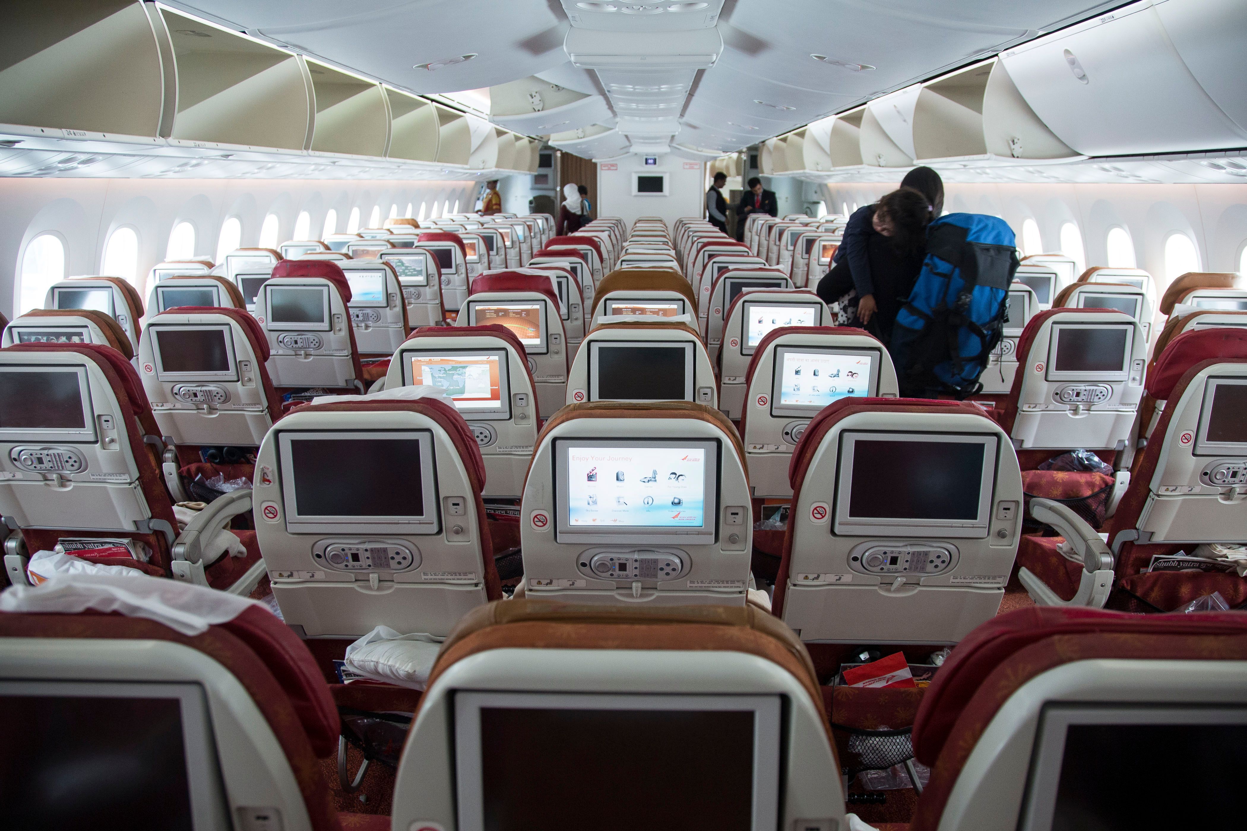 Air India Boeing 787 showing cabin seats and in-flight entertainment screen