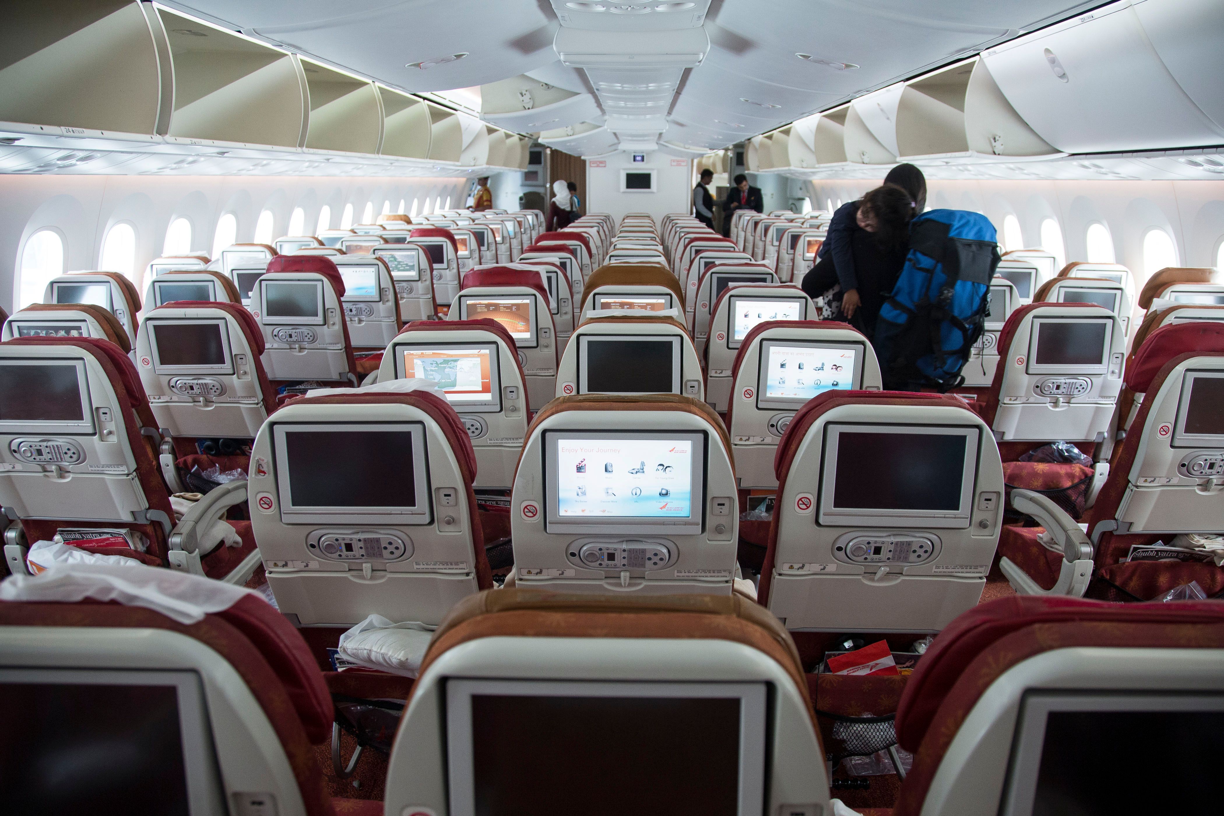 Air India Boeing 787 cabin showing seats and in flight entertainment screens