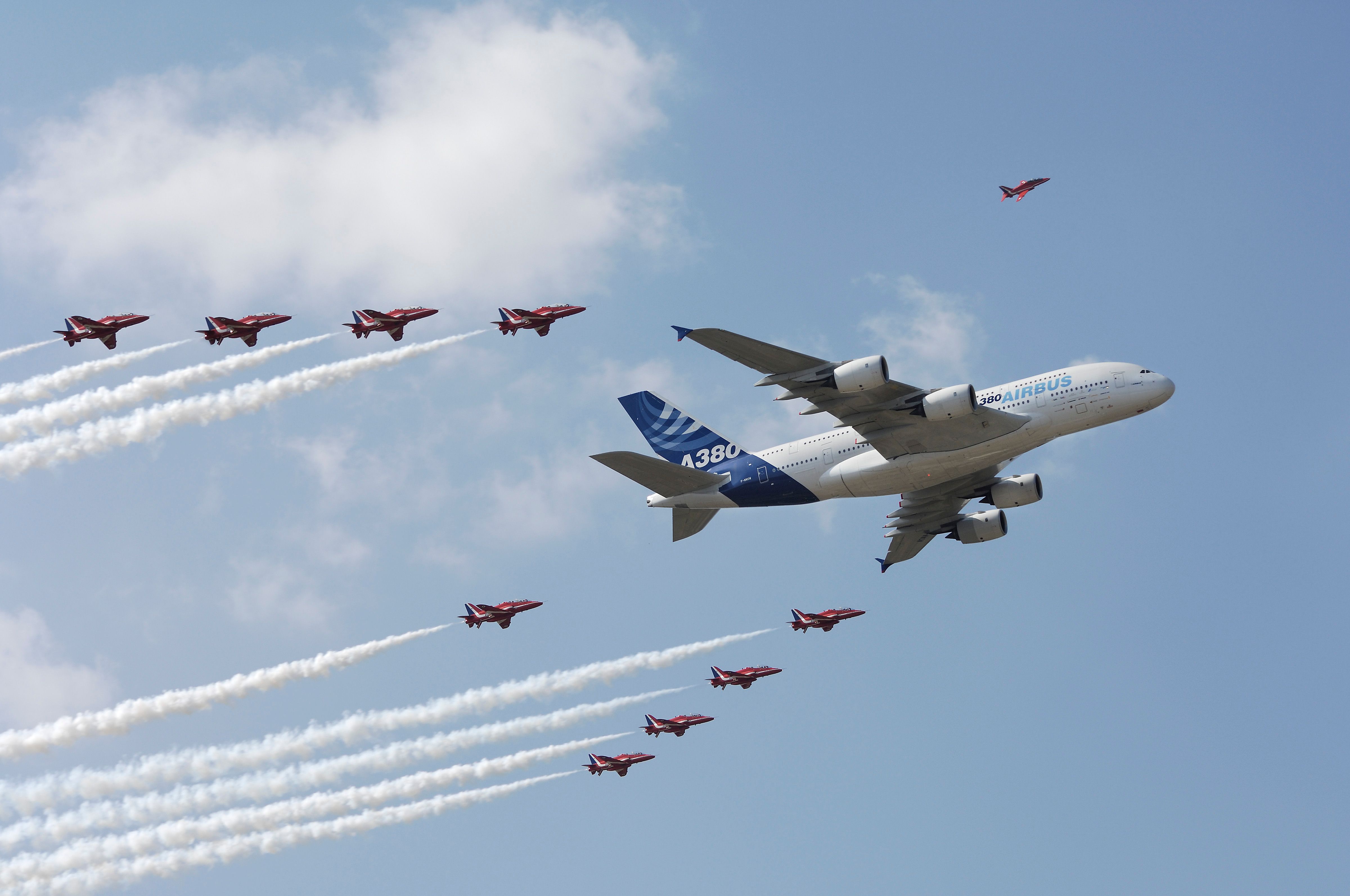 Airbus' protoype Airbus A380 flies in formation with the Red Arrows Getty Images