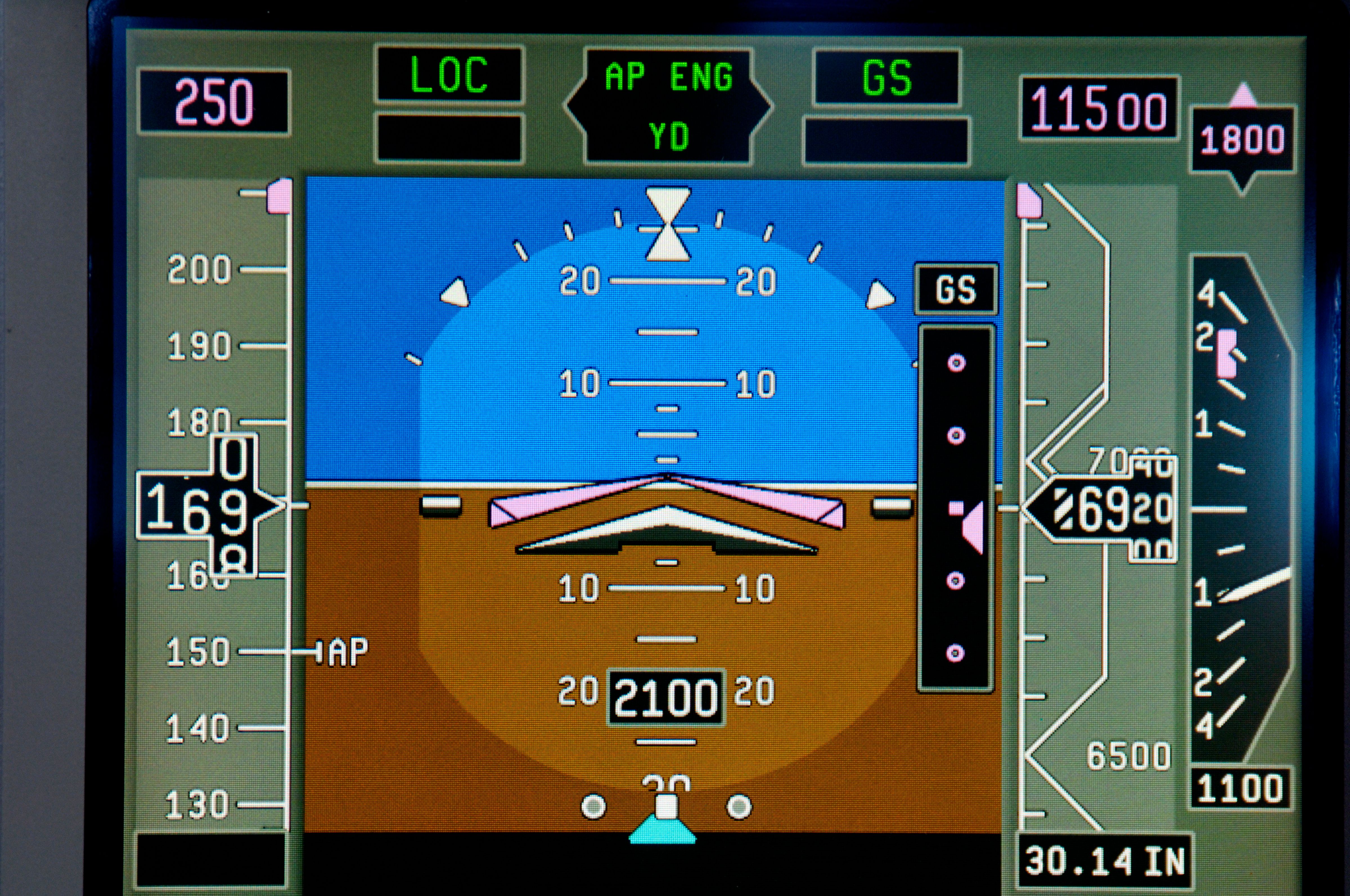 A Primary Flight Display showing 6920 feet on the altimeter with a pressure setting of 30.14 inches of mercury set (right).