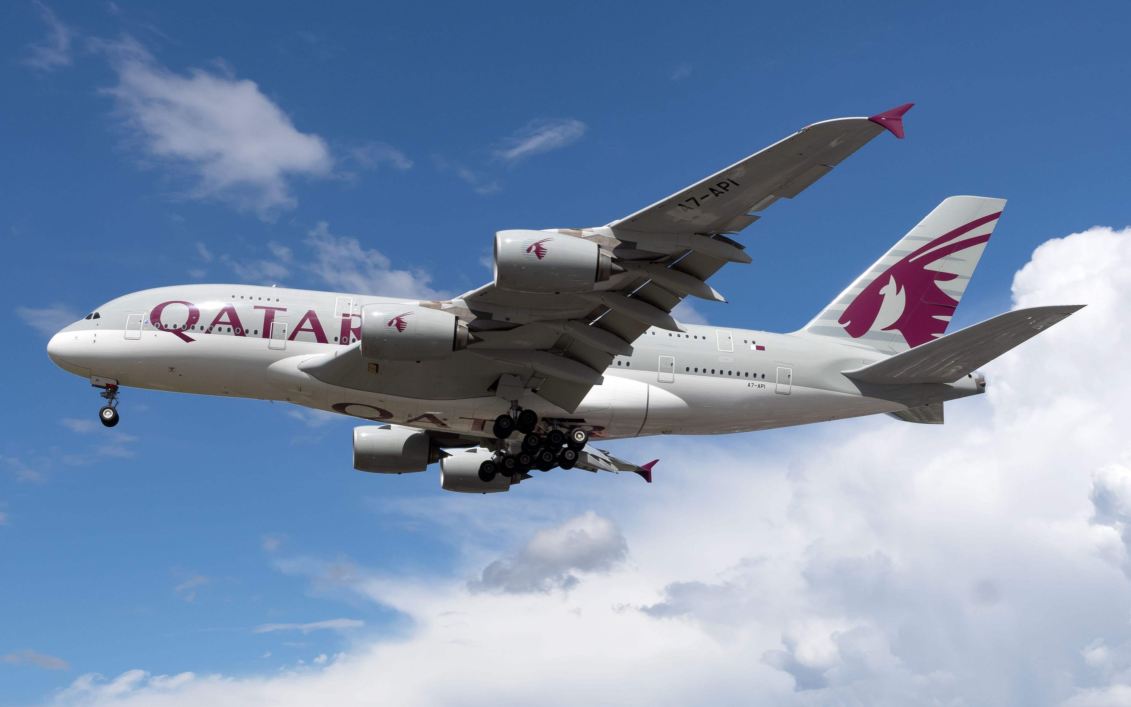 A Qatar Airways Airbus A380-861 flying in the sky.