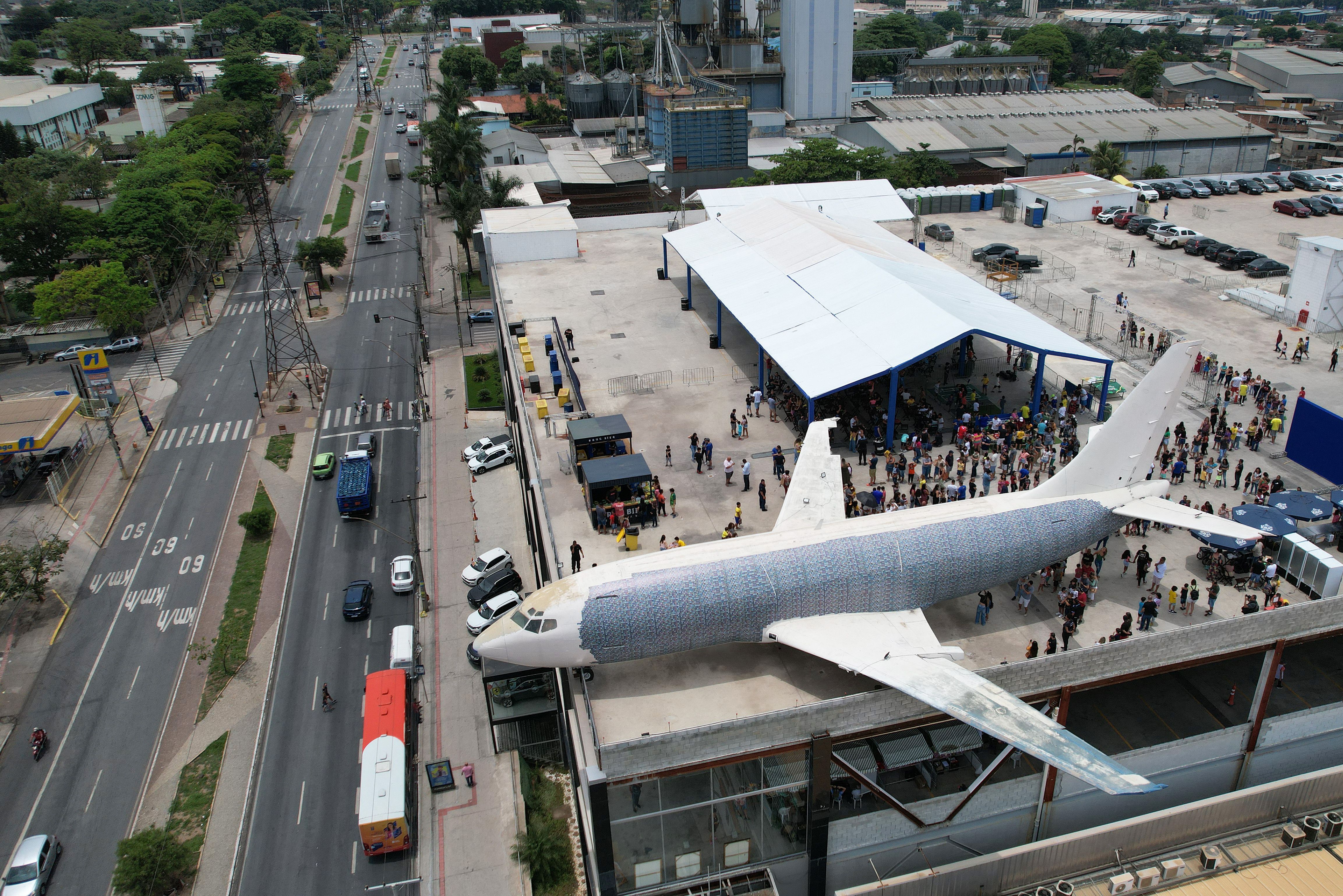Fans put on football stickers to a 737 on the roof of a shopping mall in Contagem, Minas Gerais state, Brazil