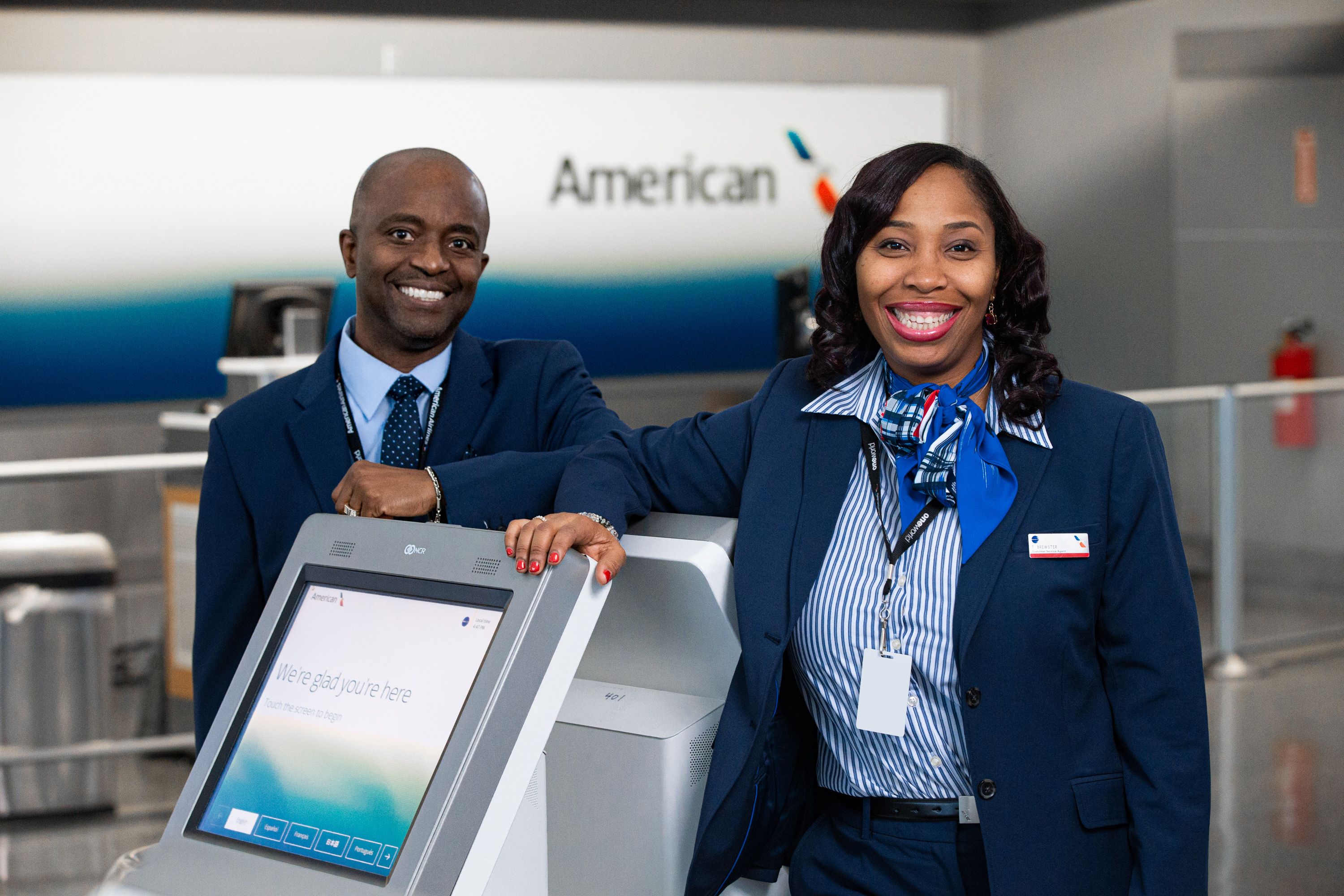Gate agents at kiosk American Airlines