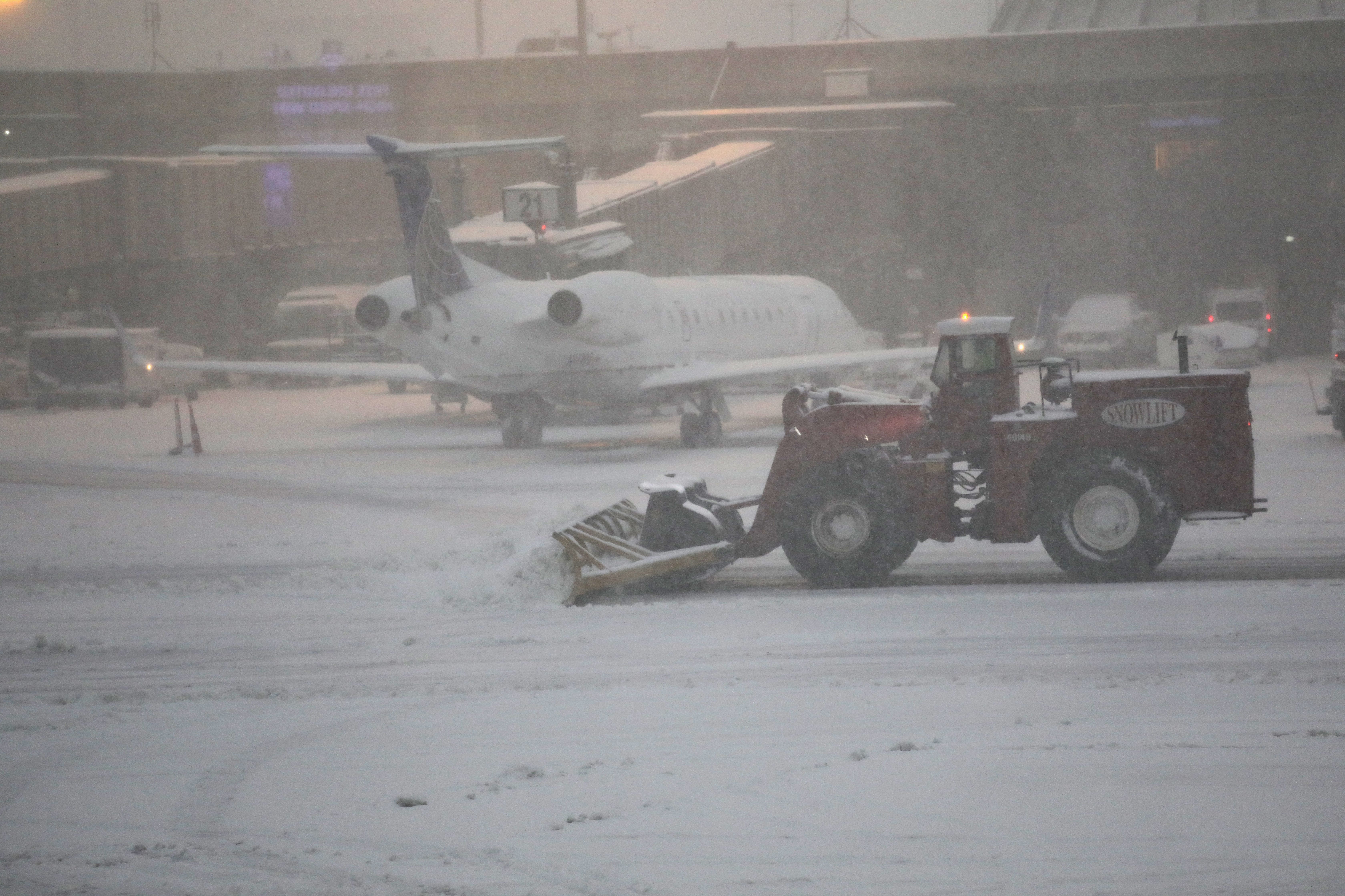 A plow clears snow during an early winter storm at the Newark Liberty International Airport on November 15, 2018 in Newark, New Jersey. The snow storm caused flight cancellations throughout the northeast. 