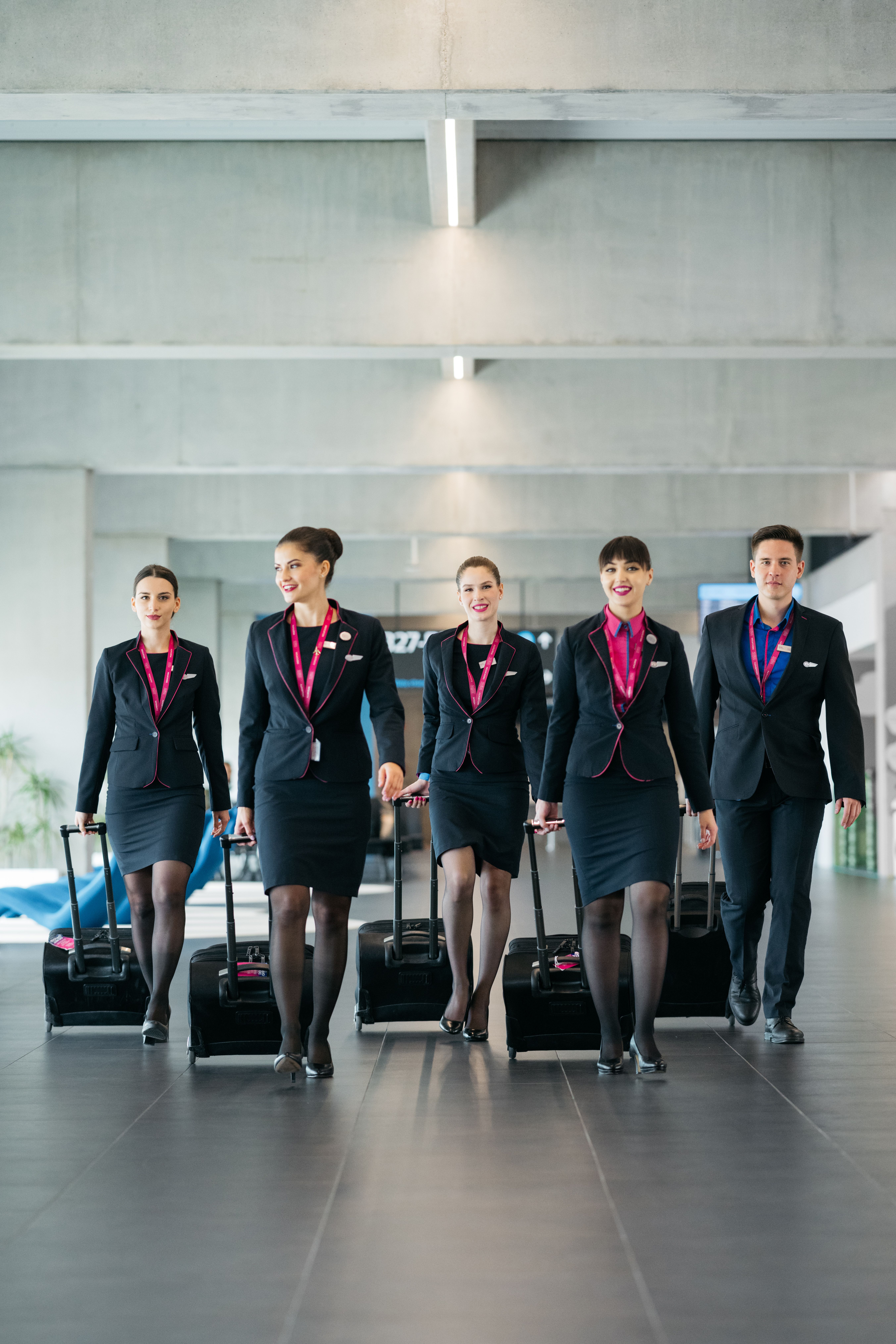 Wizzair cabin crew walking together through a car park.