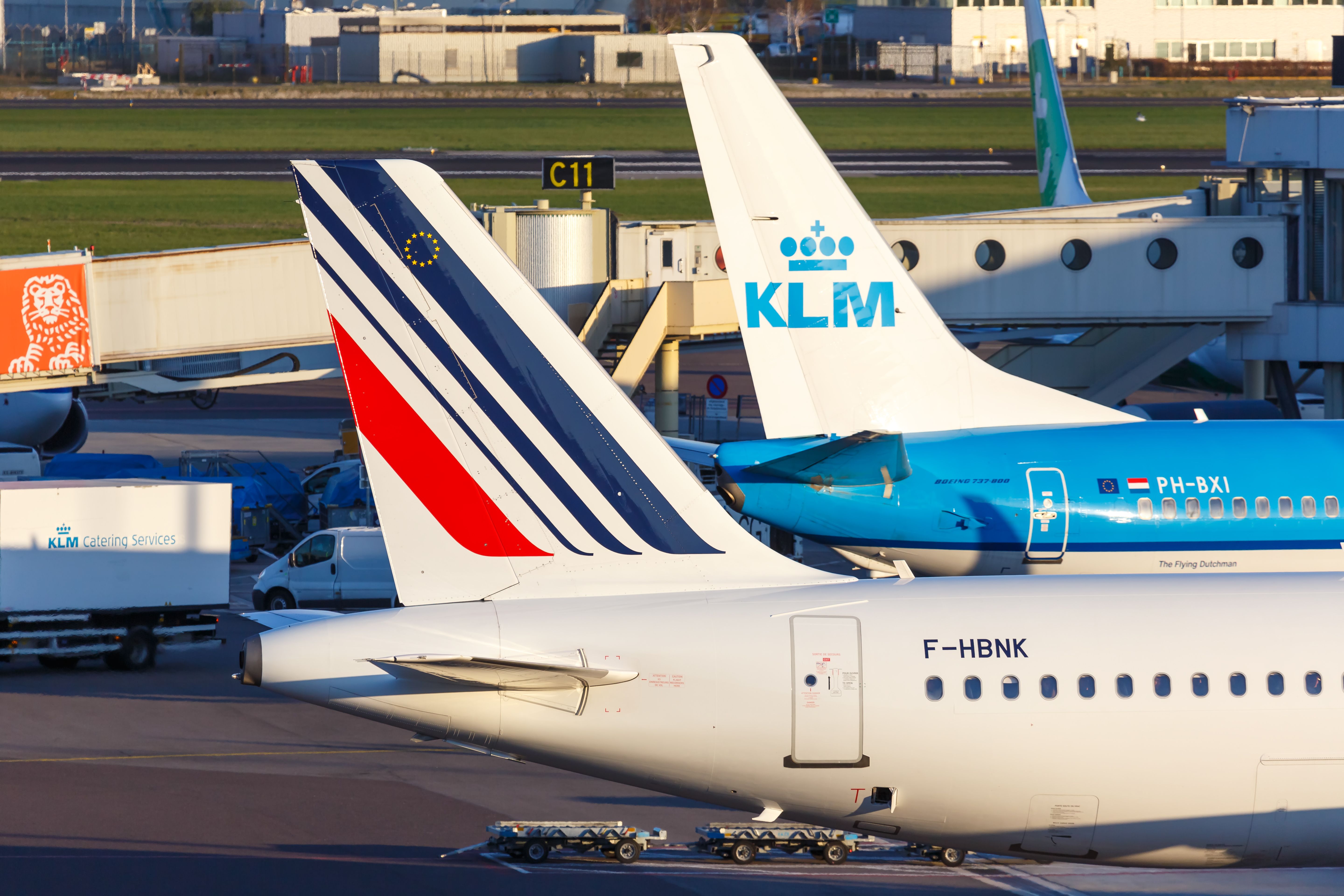 An Air France plane parked next to a KLM plane.