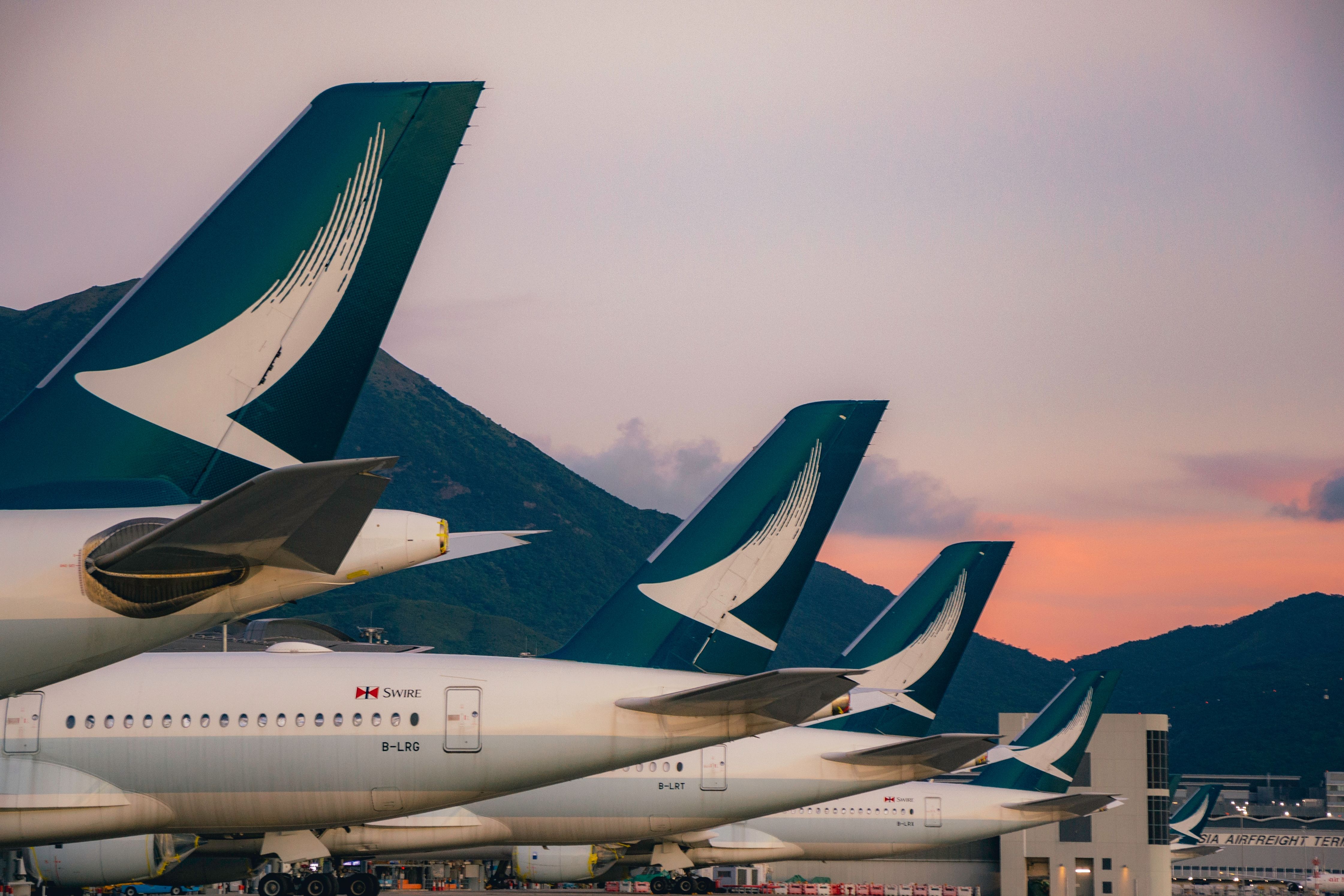 Several Cathay Pacific Aircraft parked side by side.
