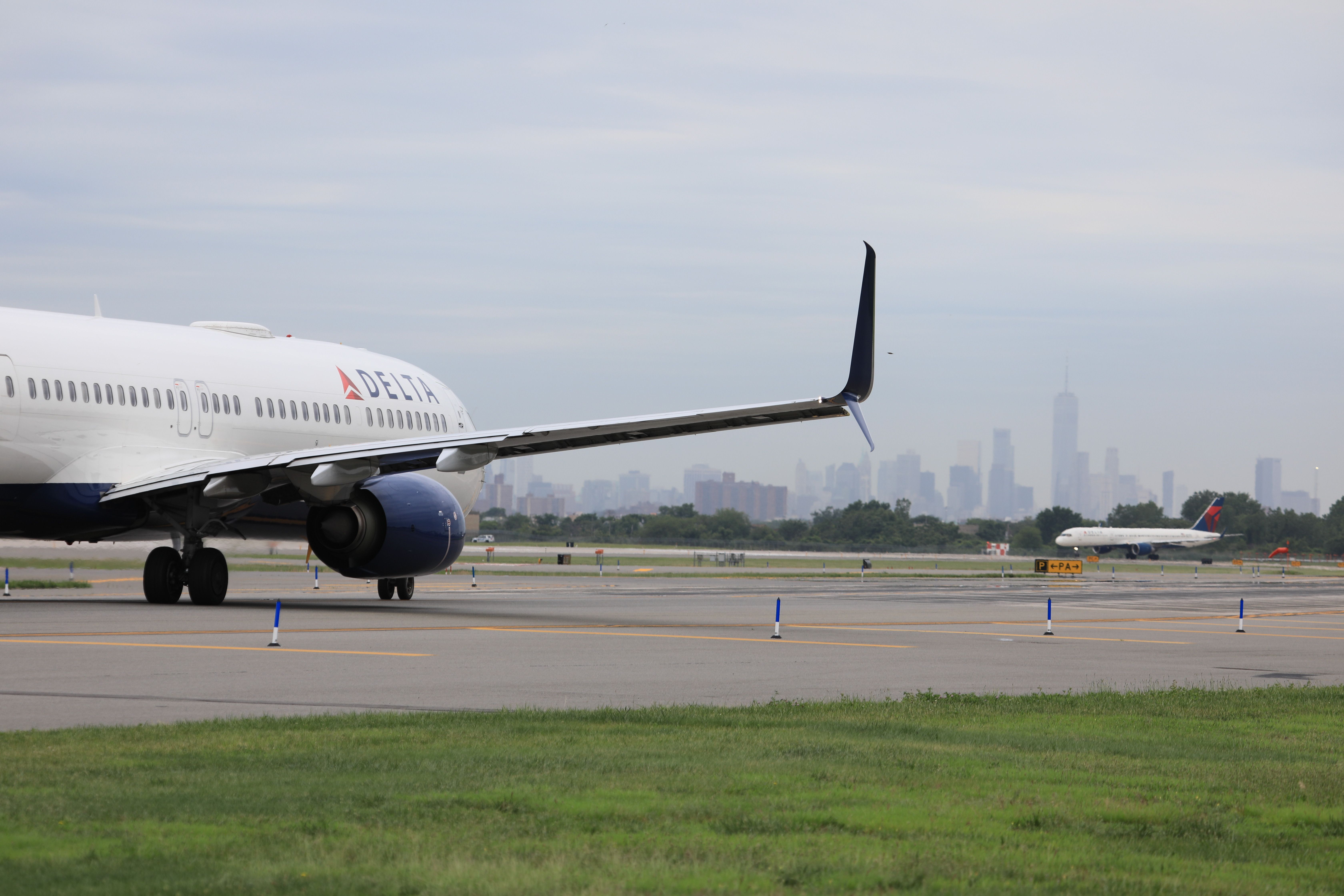 Delta aircraft at JFK with the New York Skyline