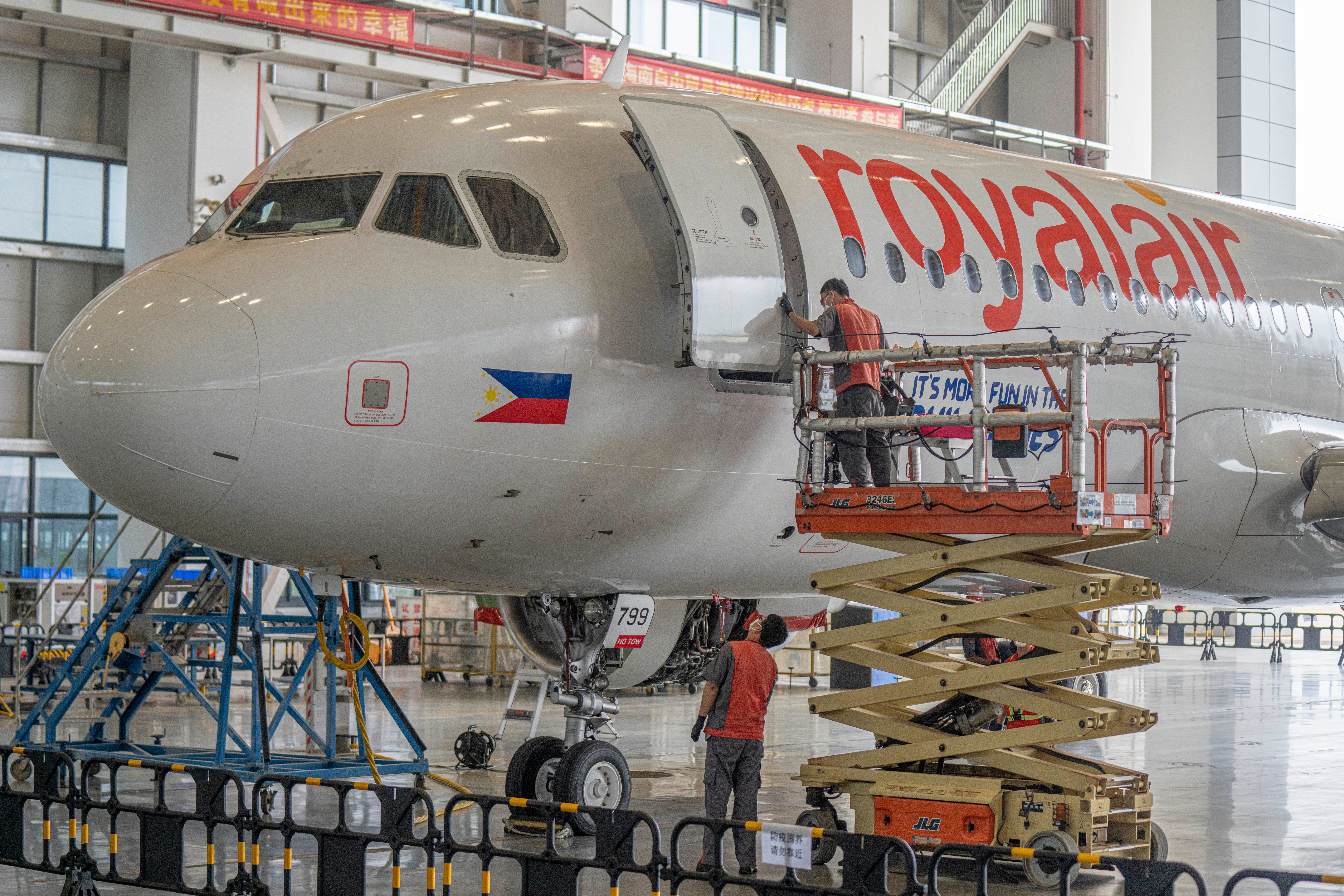 Engineers carry out maintenance work on an Airbus A320