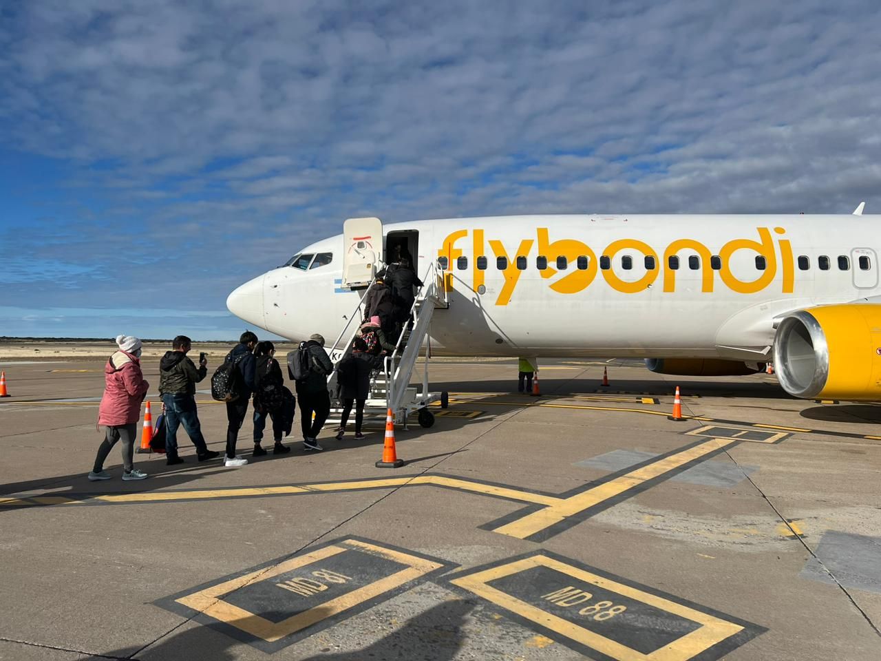 People entering a Flybondi aircraft. Flybondi is an Argentinian ultra-low-cost carrier