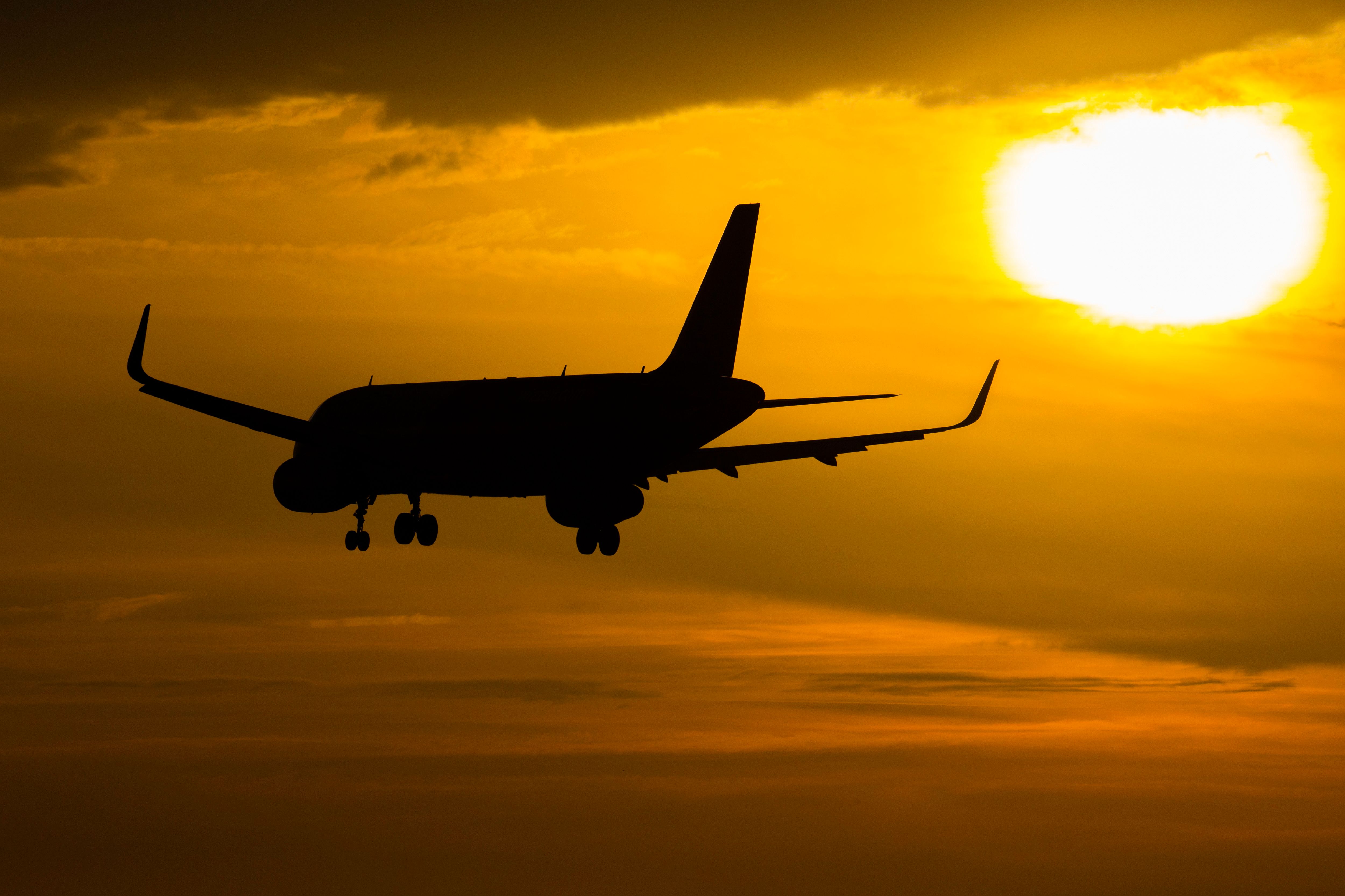 Silhouette of Wizz Air Airbus A320 arriving at Amsterdam Schiphol Airport
