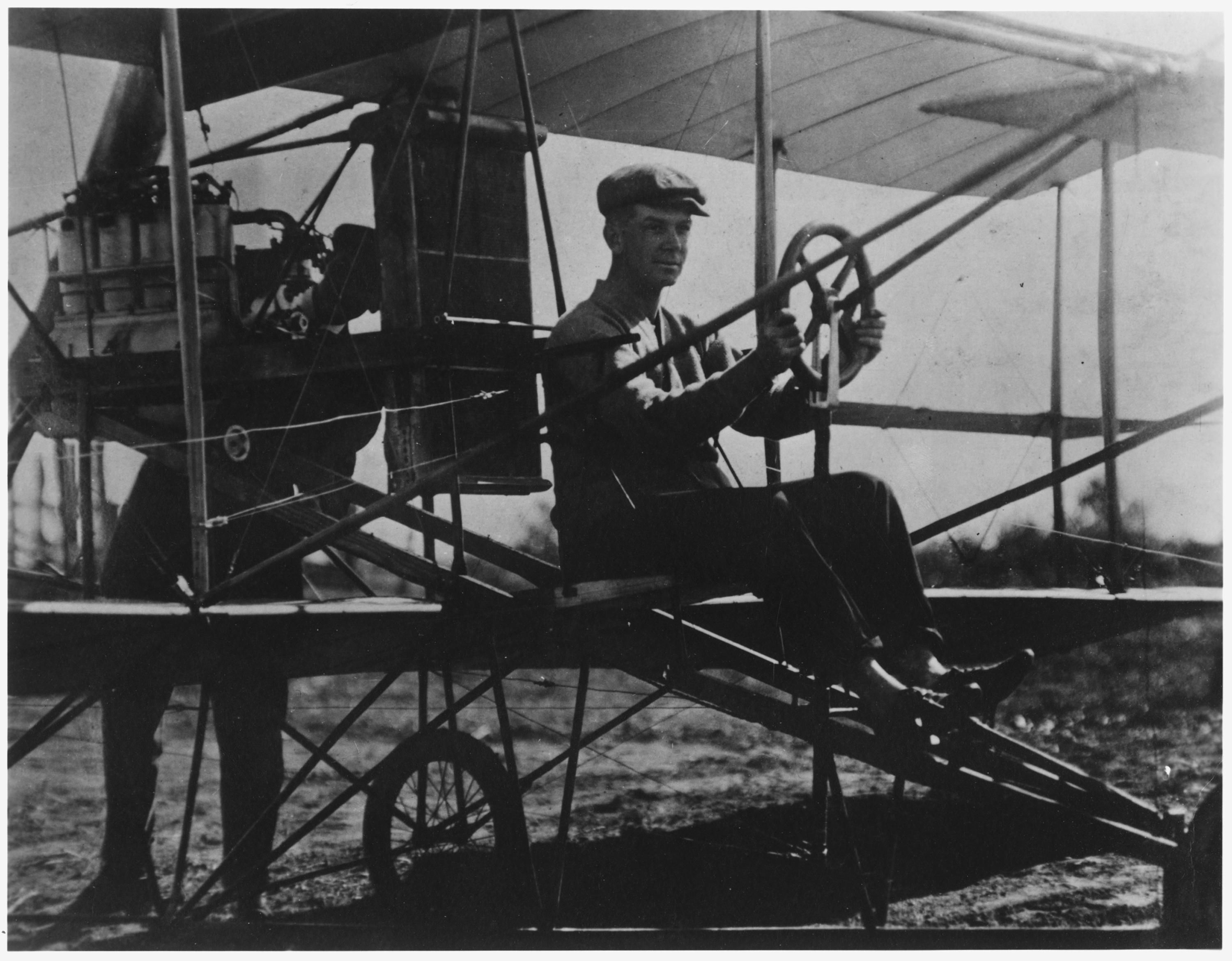 Theodore Ellyson and Glenn Curtiss using an early aircraft.