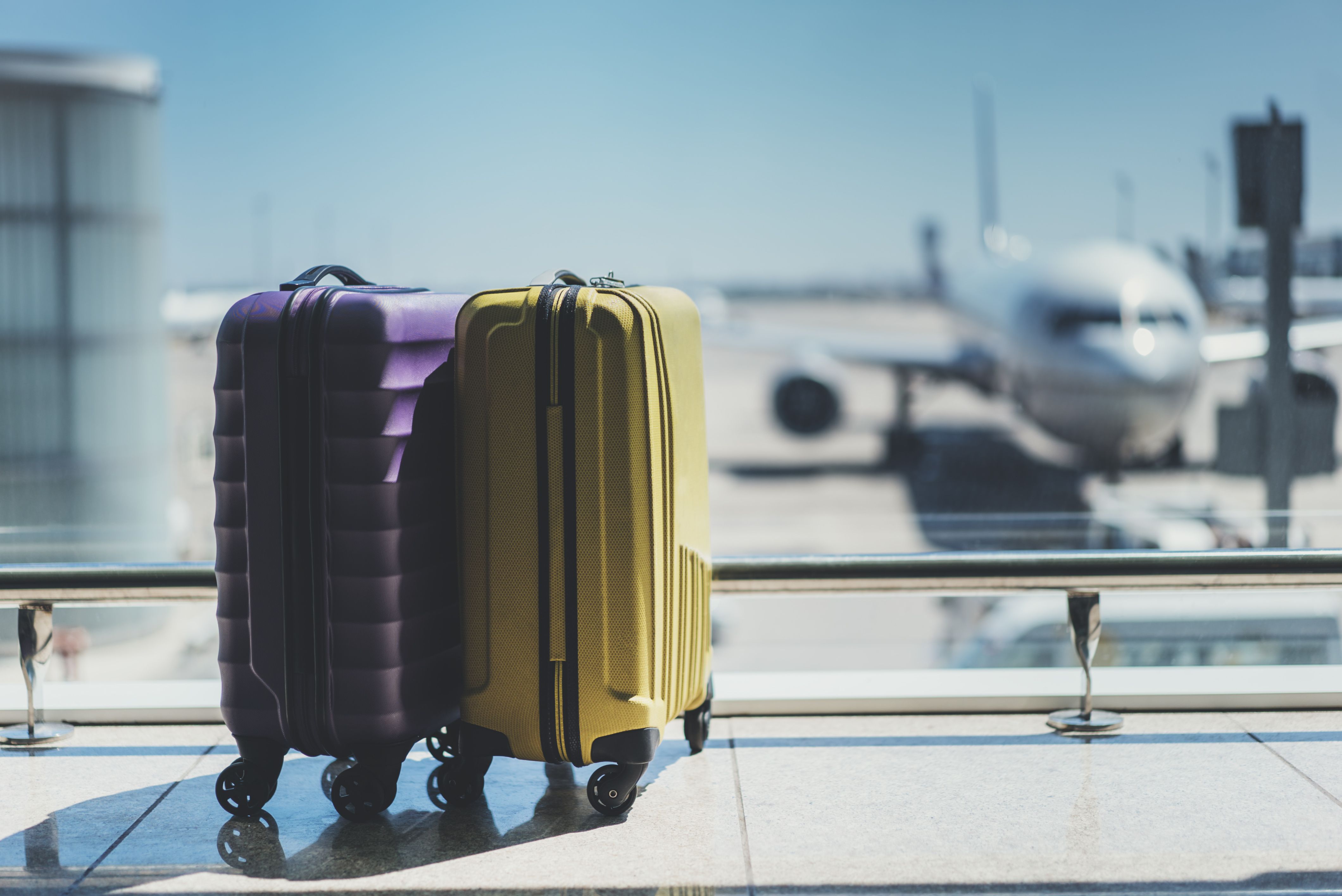 Luggage and Aircraft in Background Shutterstock