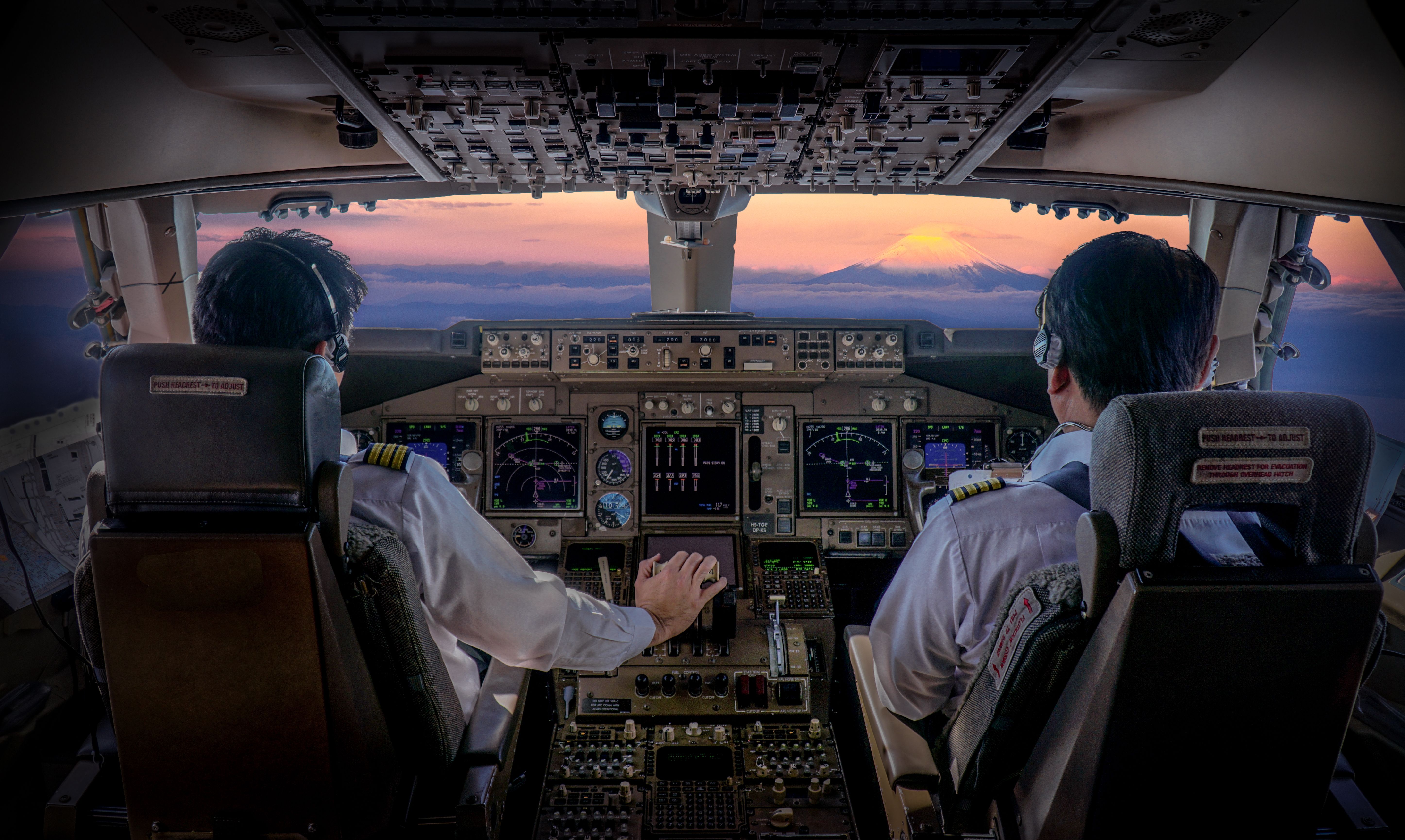 Two pilots work together on the flight deck.