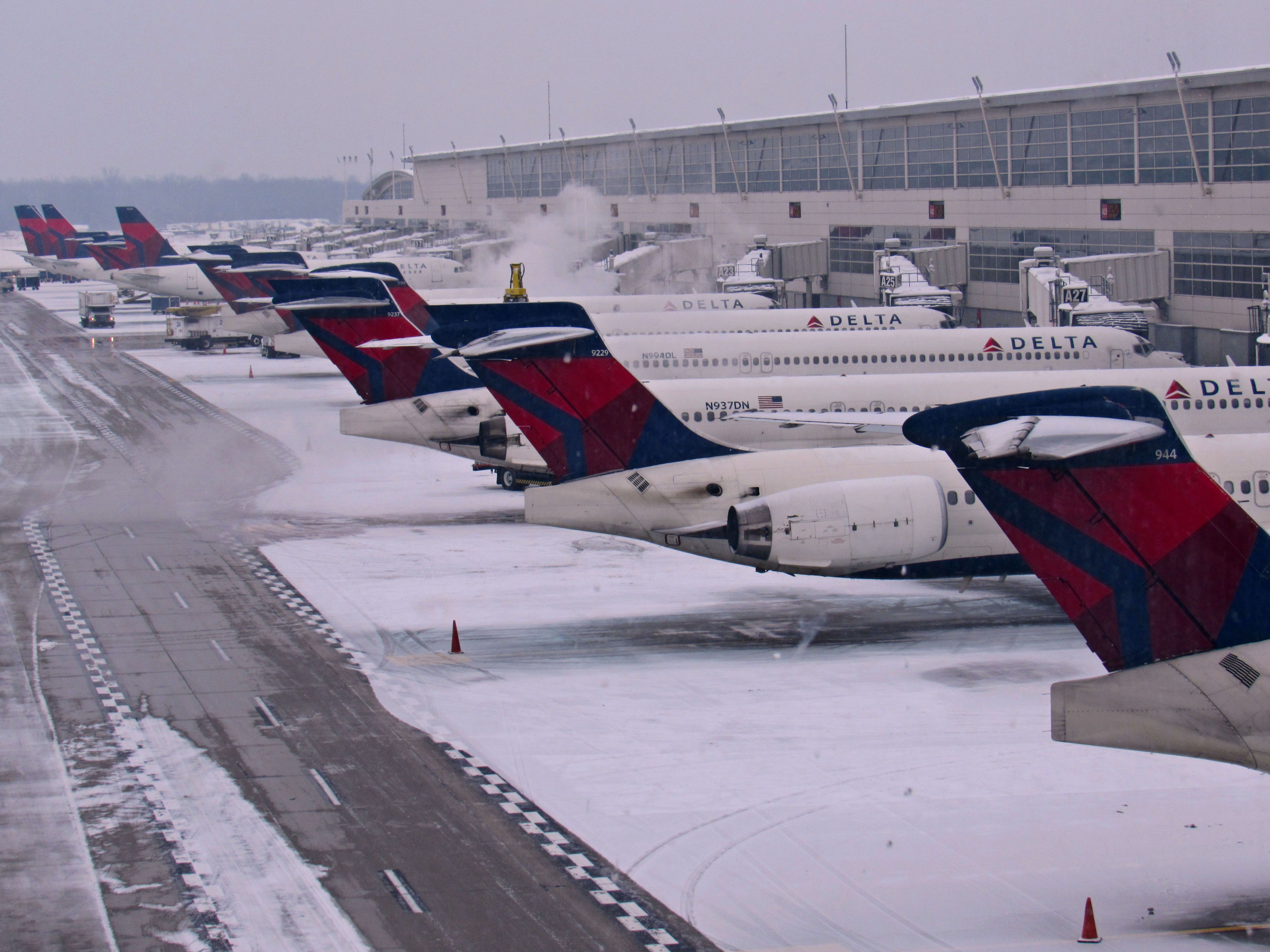 A line-up of Delta Air Lines aircraft in the snow